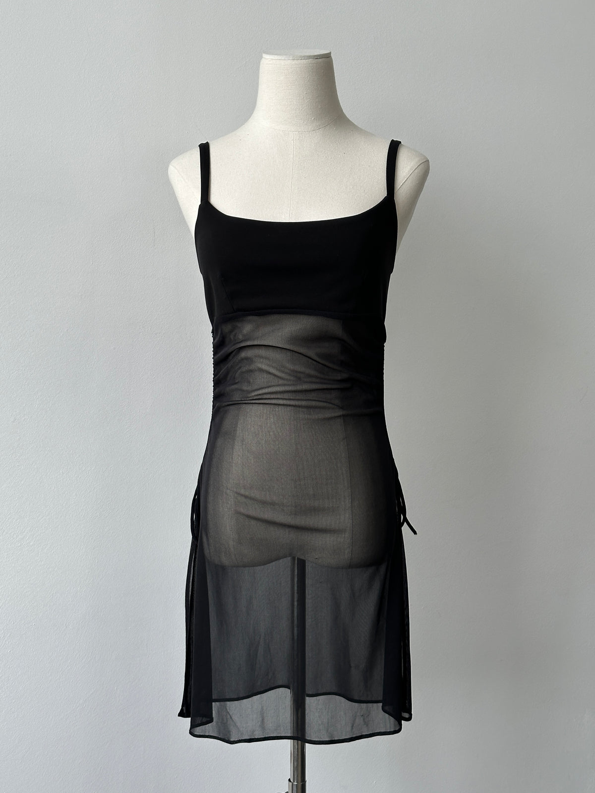 French vintage 1990s sheer sleeveless top by Vintage, featuring delicate fabric and classic design, shown on a hanger.