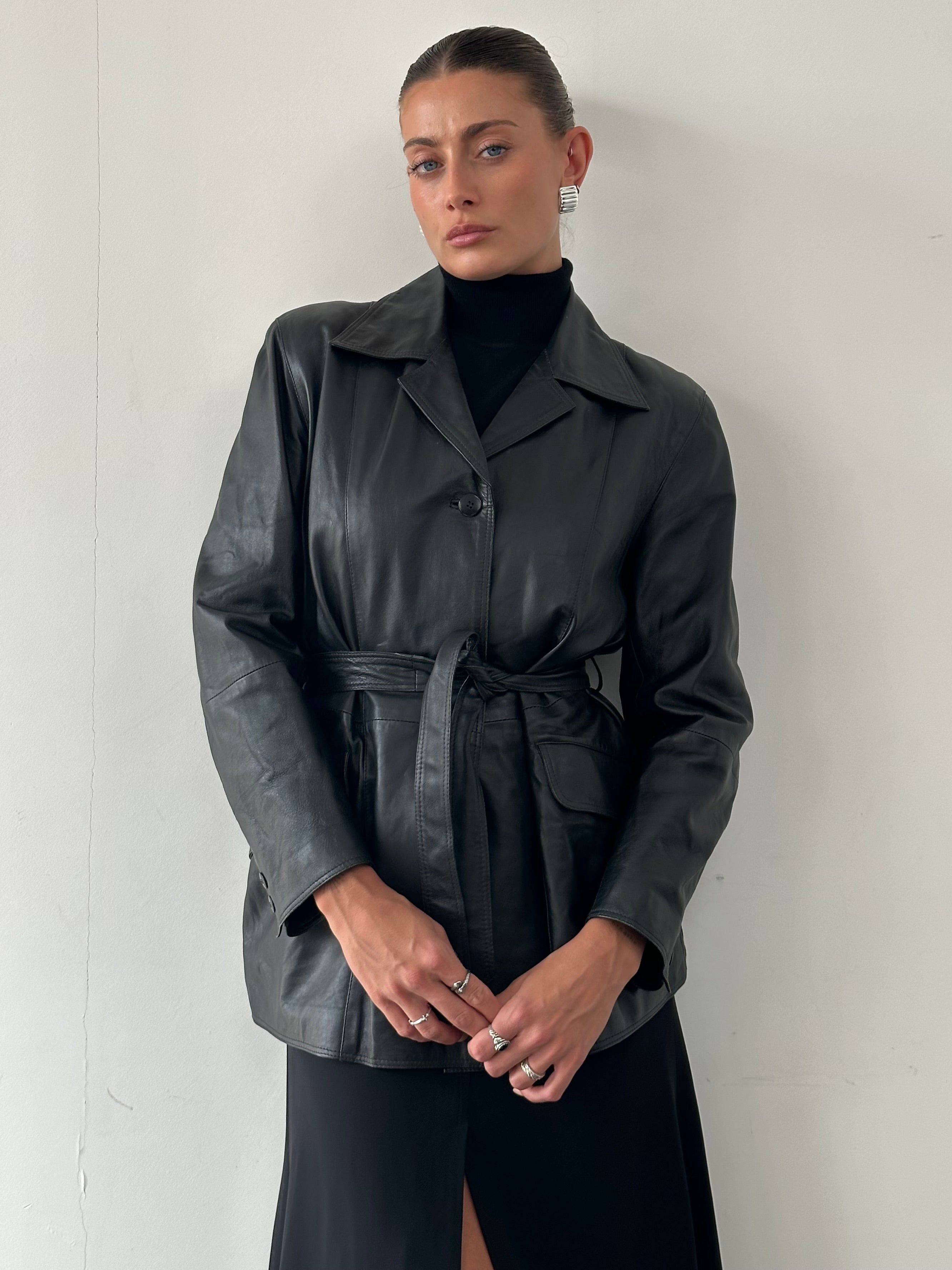 Conbipel belted leather jacket in size M, featuring a stylish design with a belt and classic leather texture.