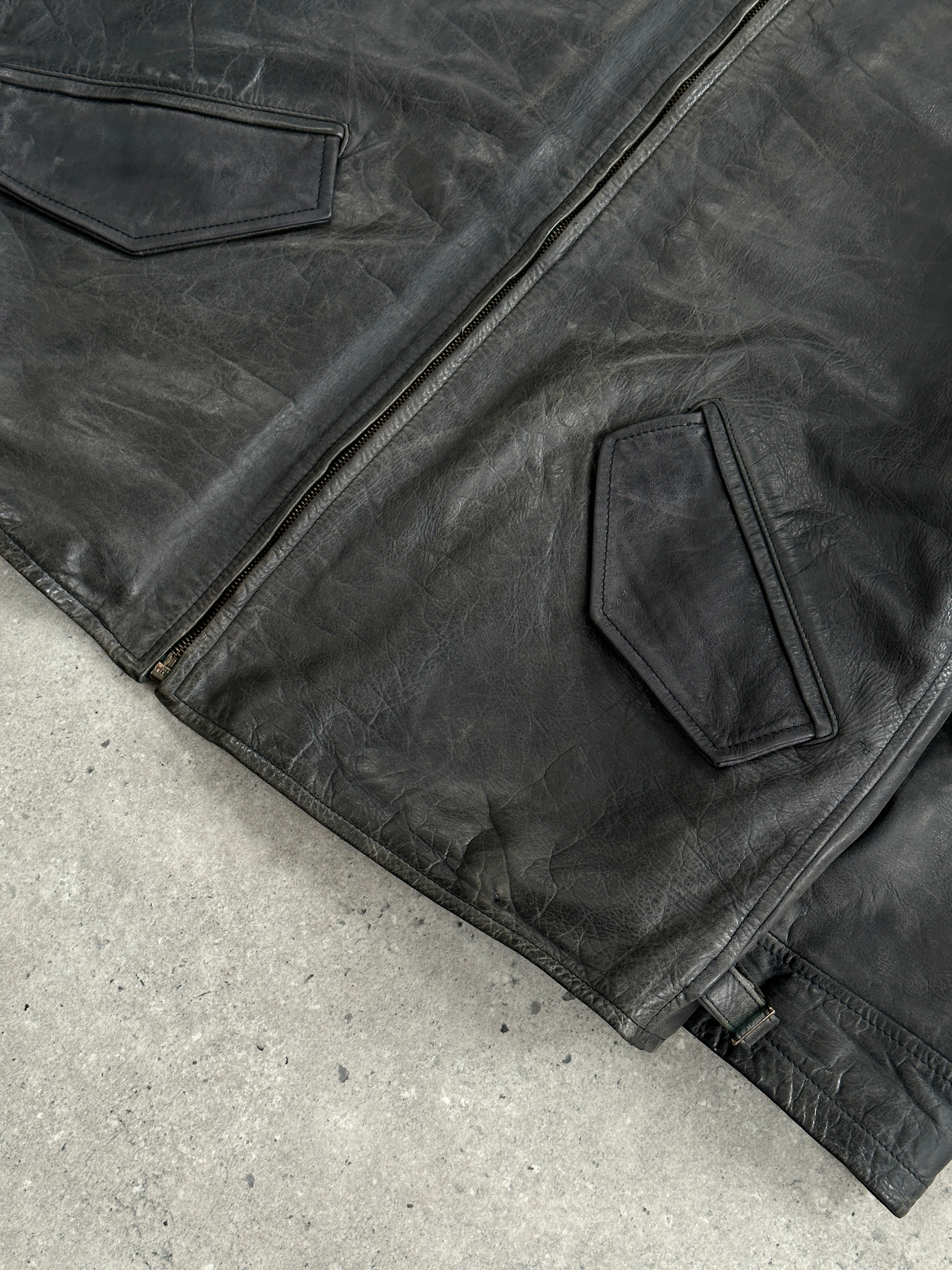 Vintage 1990s aged boxy leather jacket in size L/XL, featuring distressed brown leather and classic design.