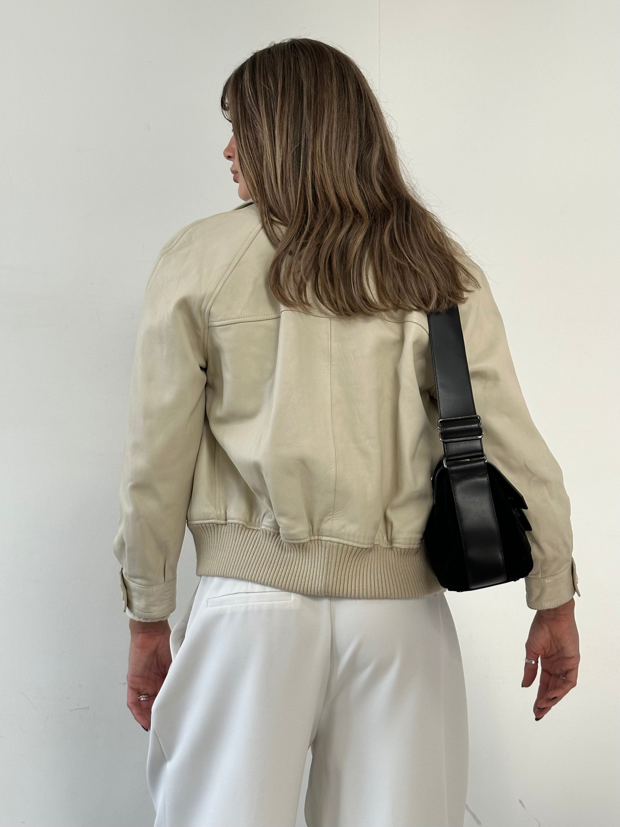 Vintage Leather Bomber Jacket in size S, featuring classic design, brown color, and ribbed cuffs and collar.