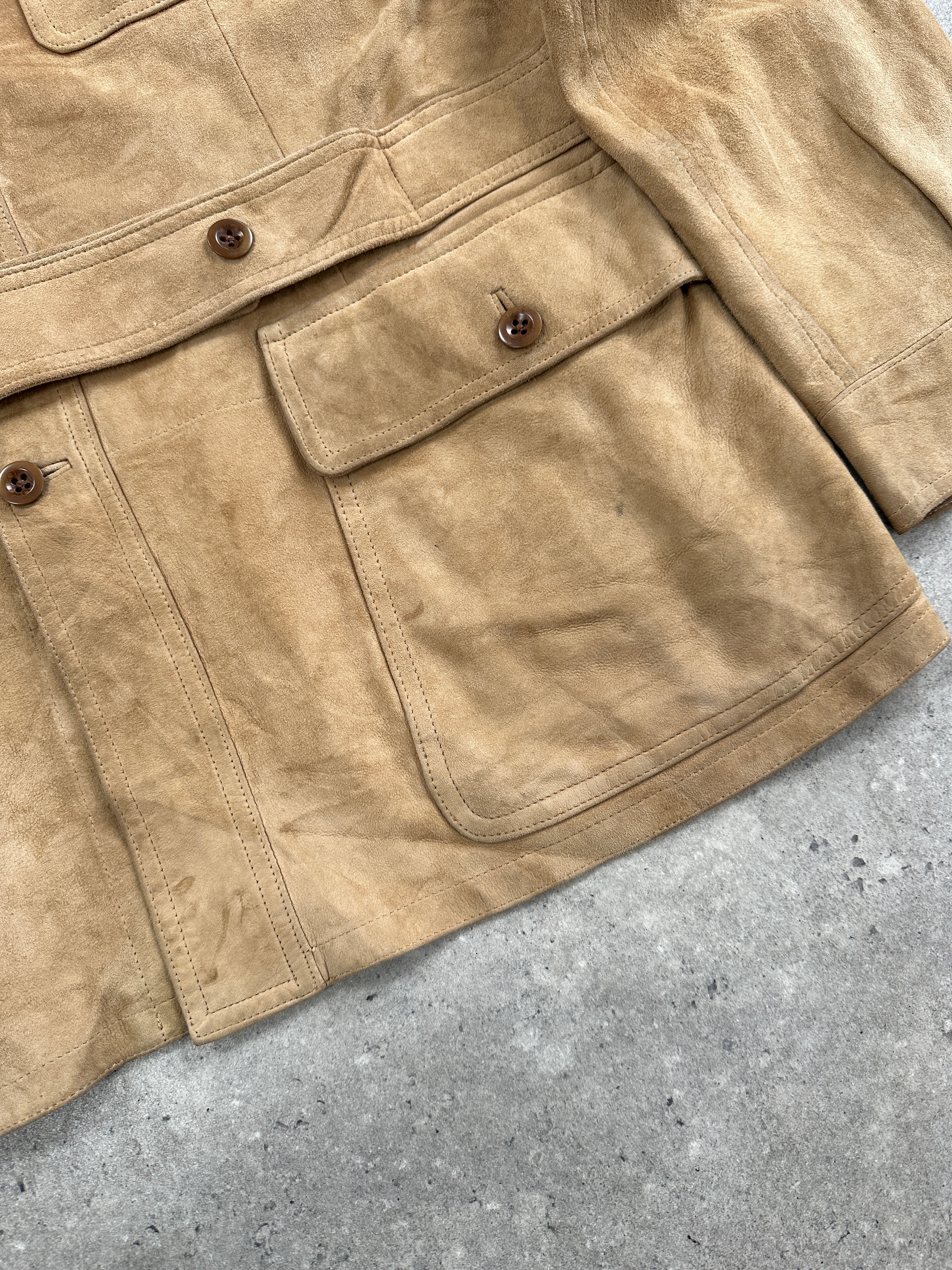 Ralph Lauren Polo 2000s safari suede jacket in XL displayed on a hanger, showcasing its tan color and classic design.