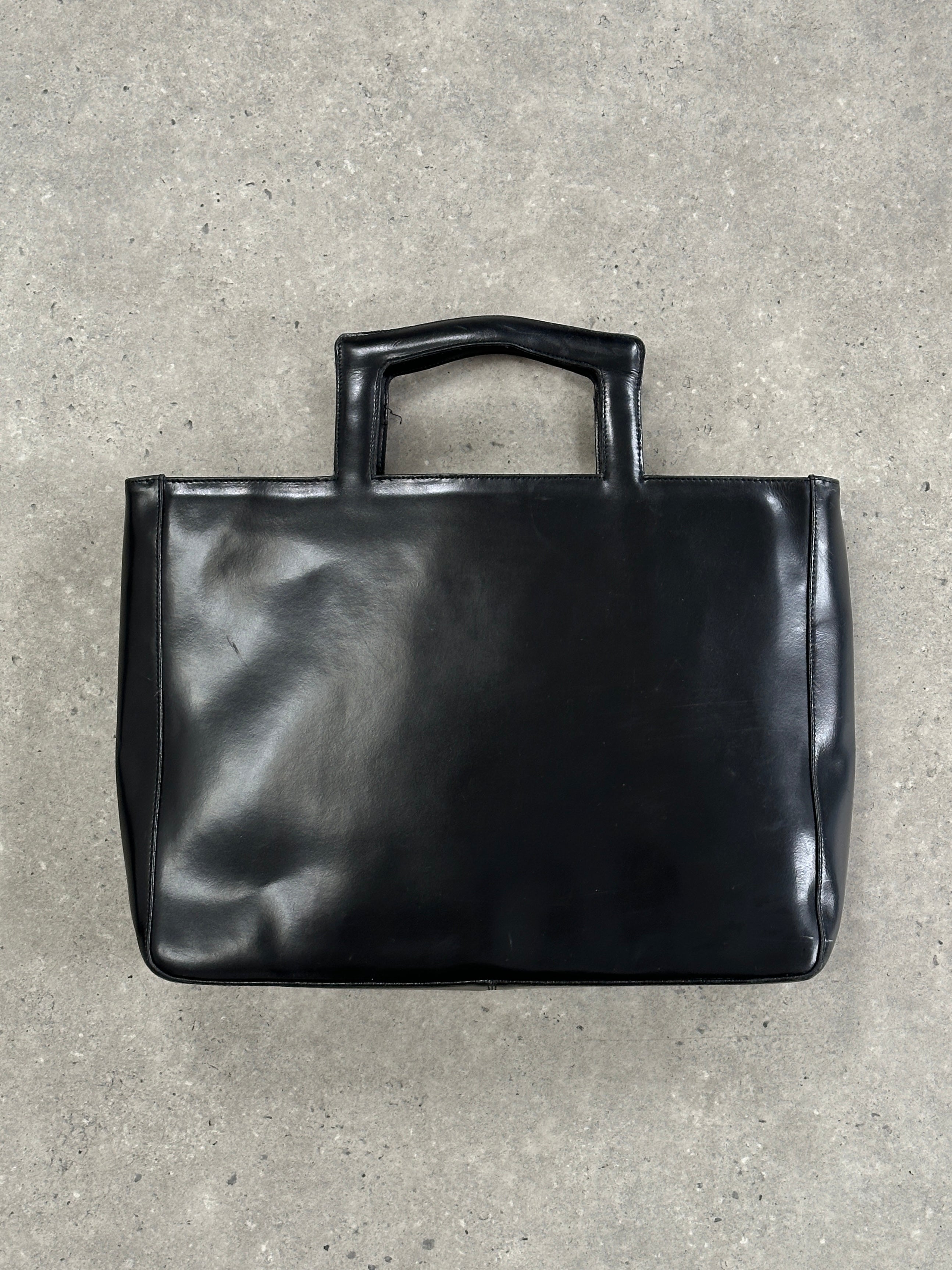 Italian vintage leather briefcase bag with classic design, featuring sturdy handles and detailed stitching.