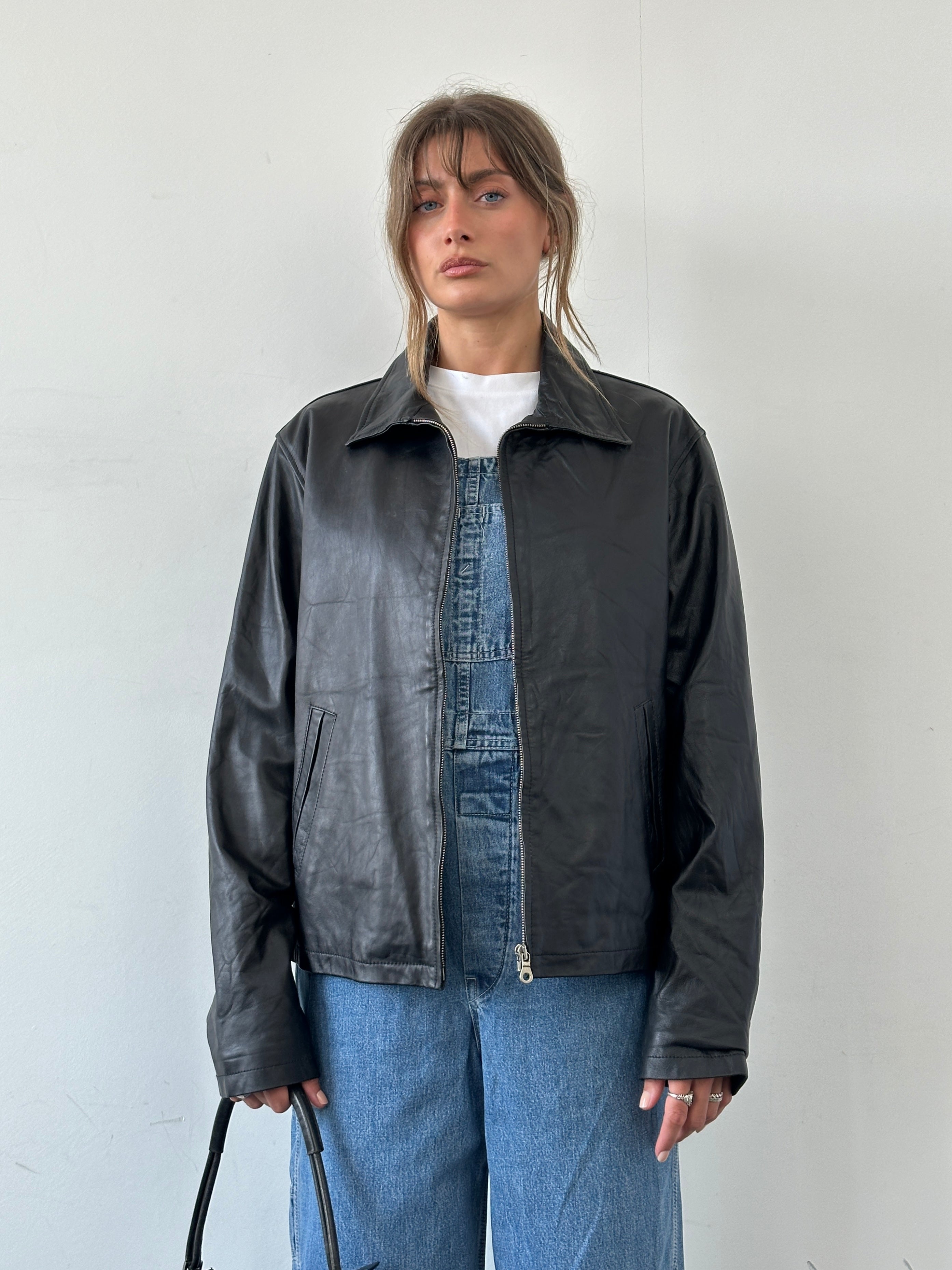 Italian vintage minimal leather jacket by Vintage, front view showing zip-up closure and sleek design in size L.