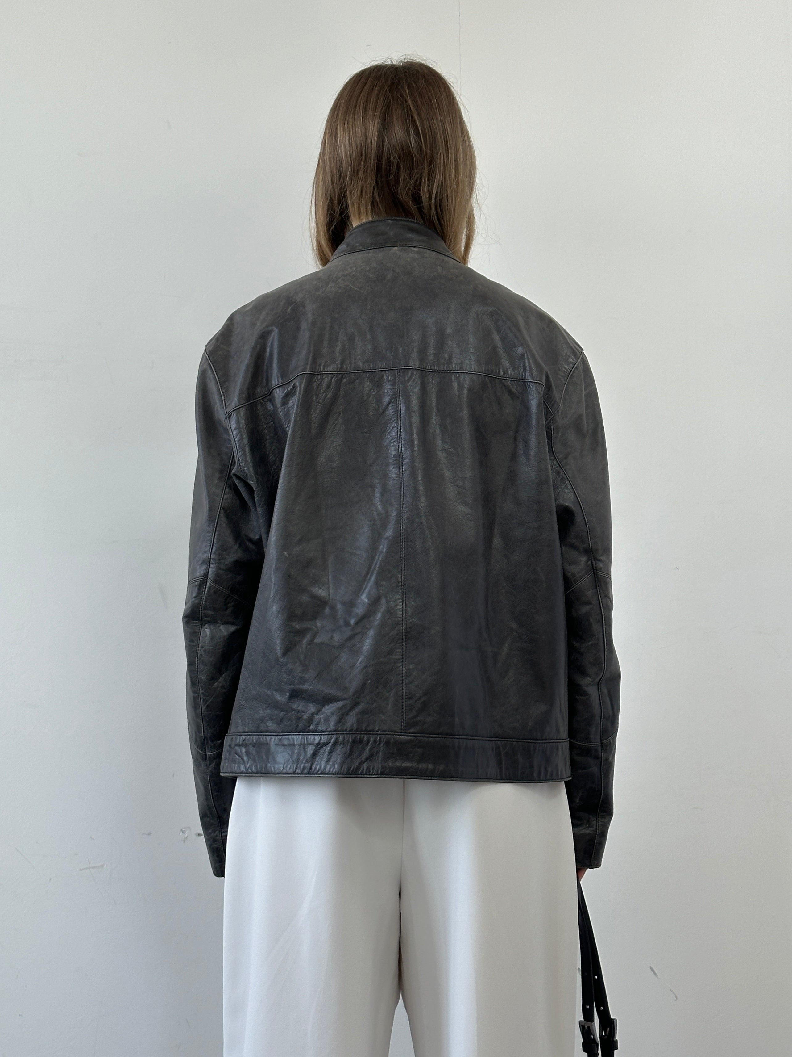 Vintage distressed leather motorcycle jacket in size L/XL, featuring rugged design and classic moto style.