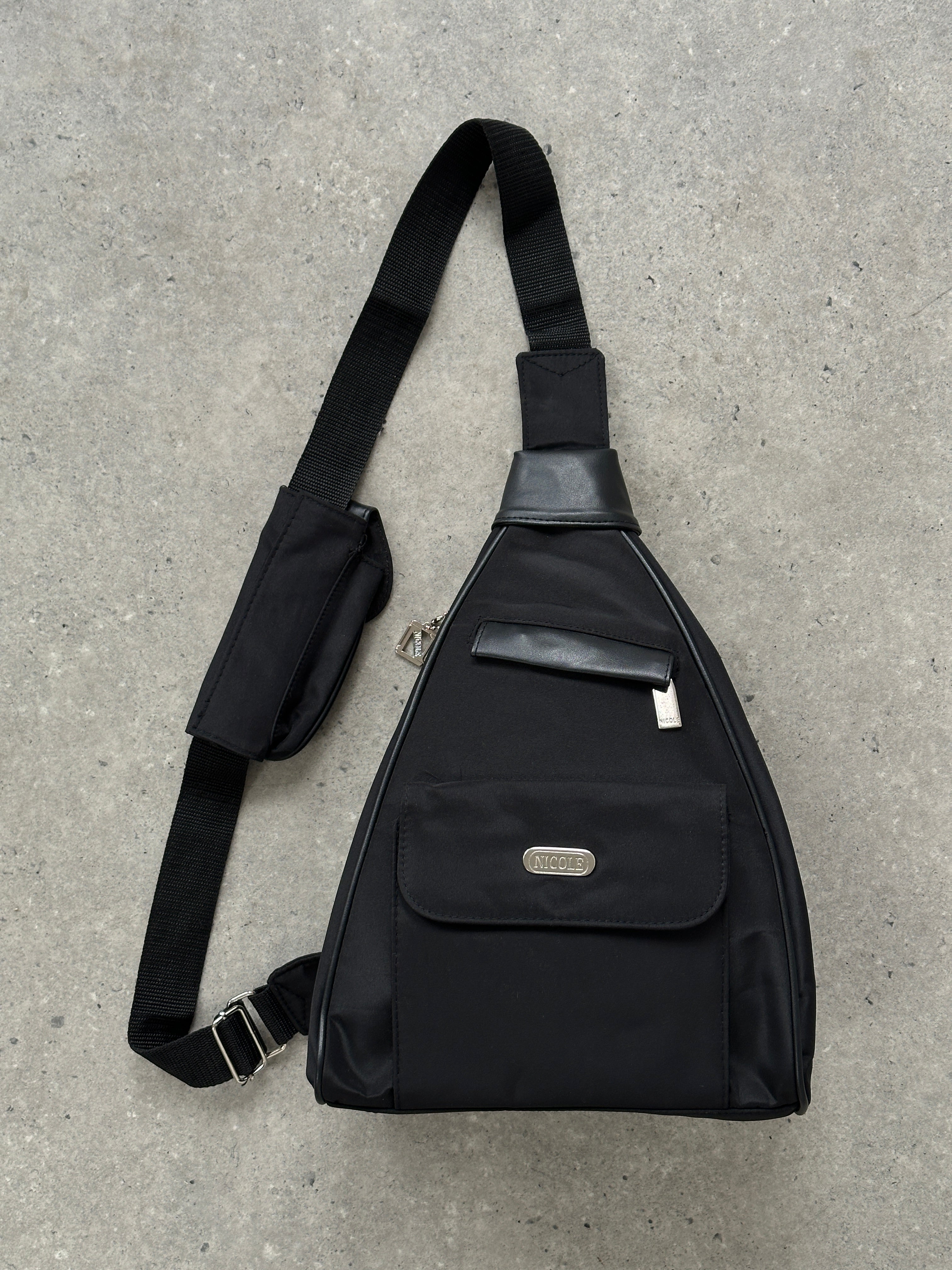 Vintage sling bag with adjustable strap and classic design, made of durable material, perfect for casual or stylish everyday use.