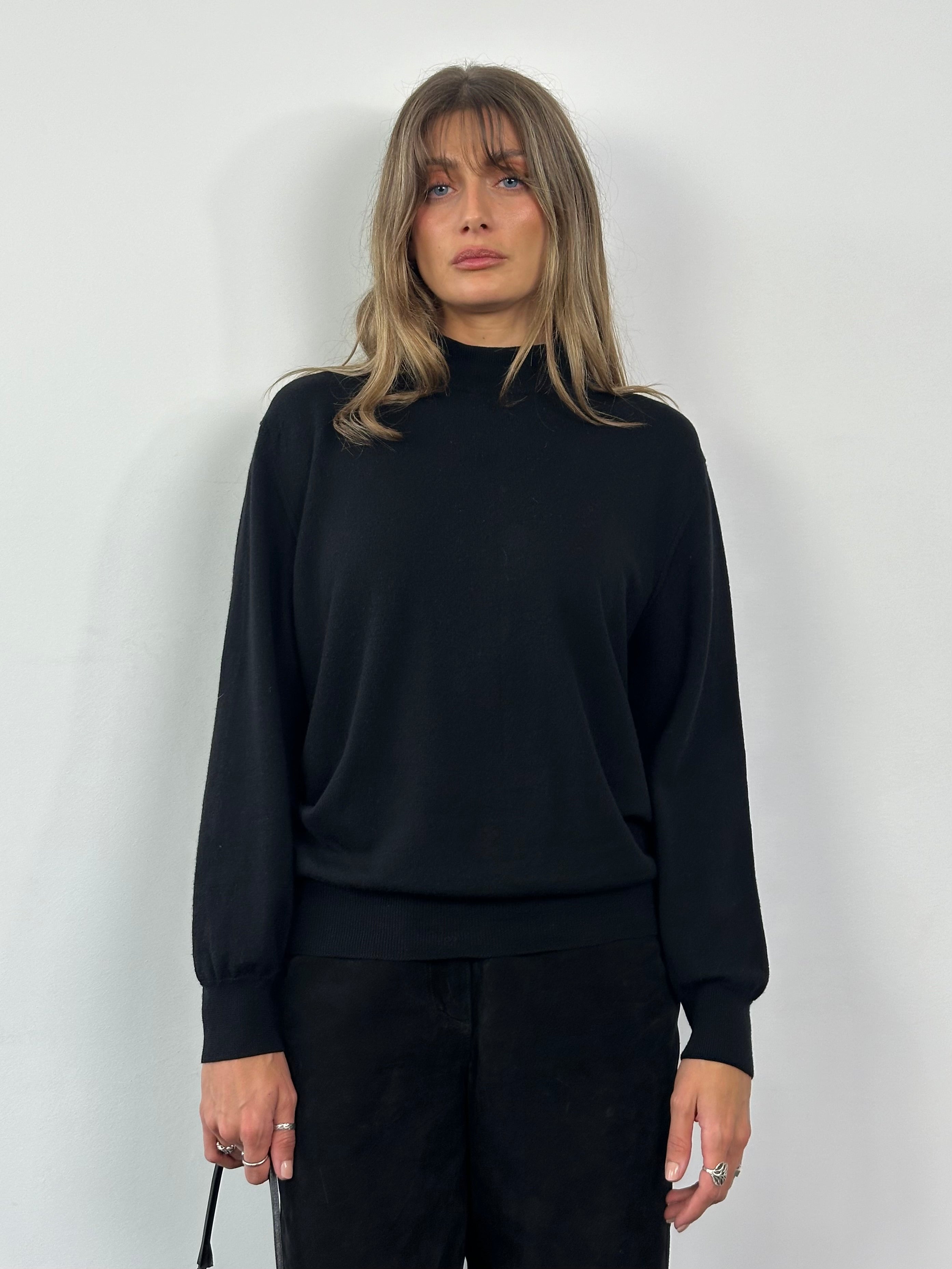 Valentino pure wool logo turtleneck jumper in black, featuring a high neckline and Valentino branding on the chest.