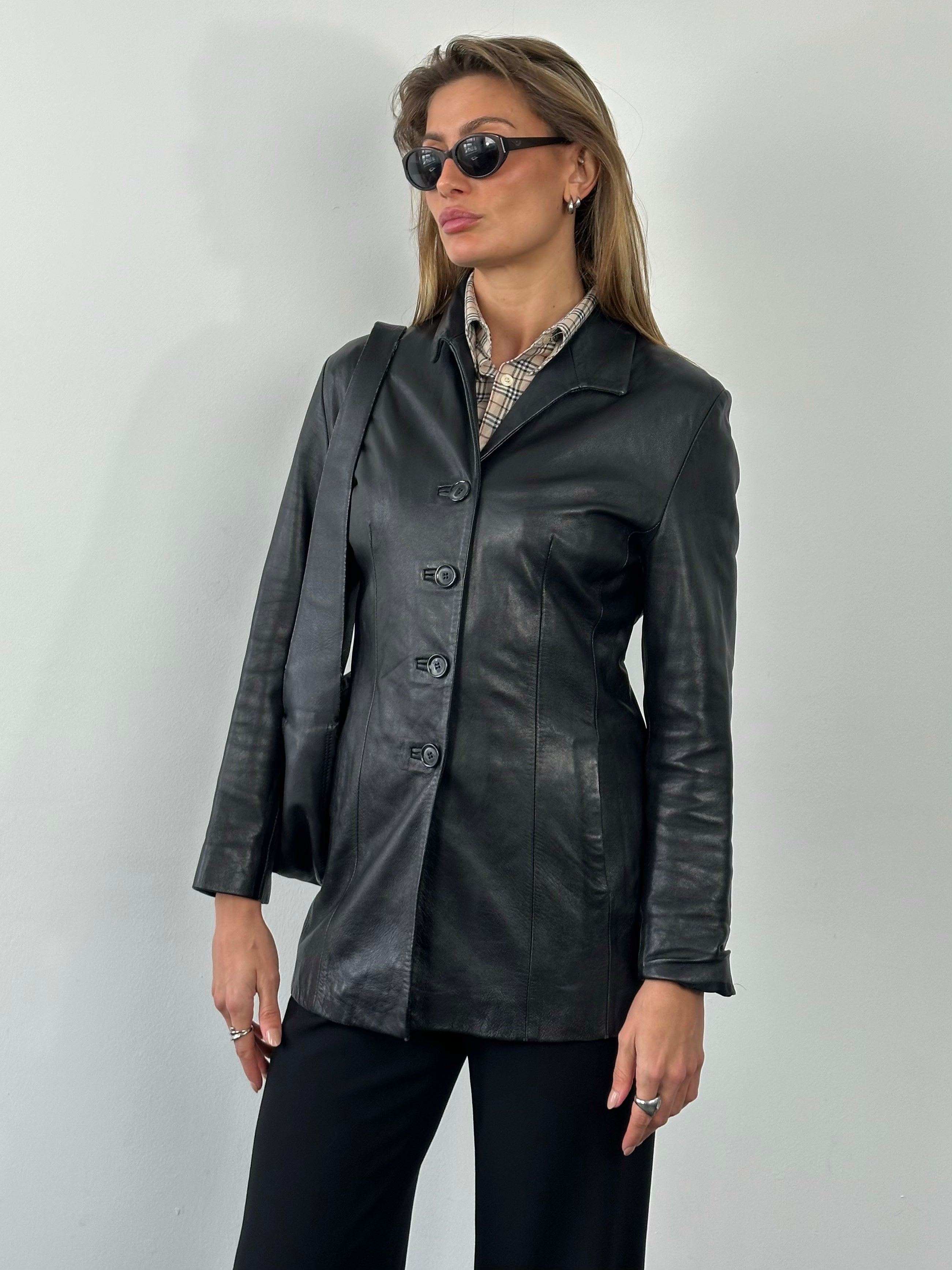 Vintage British 1990s fitted leather jacket in black, featuring a classic design and zip closure, size small.