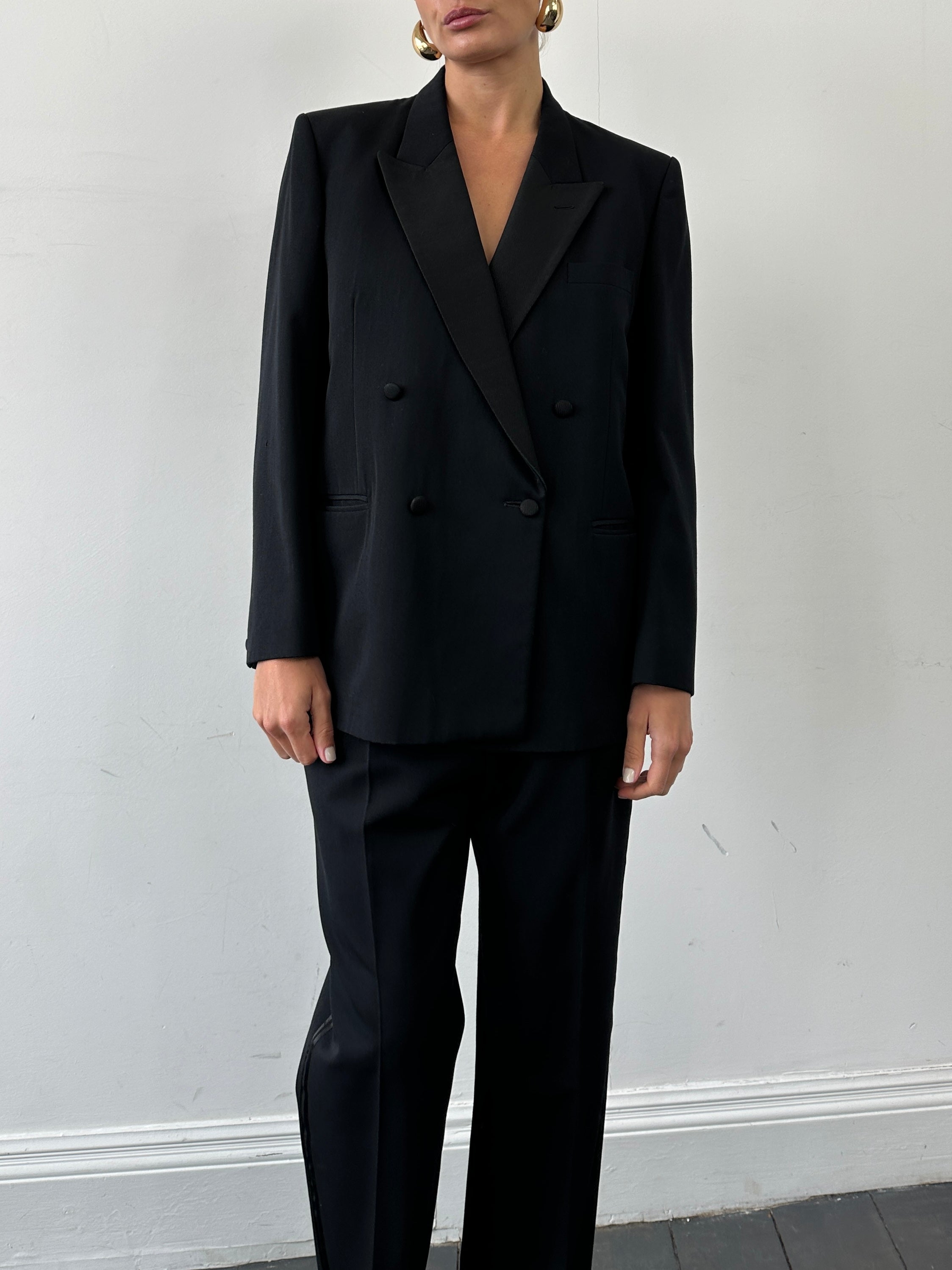 Christian Dior Monsieur tuxedo jumpsuit, double-breasted design, in size 42S/W34, styled for formal wear with tailored details.