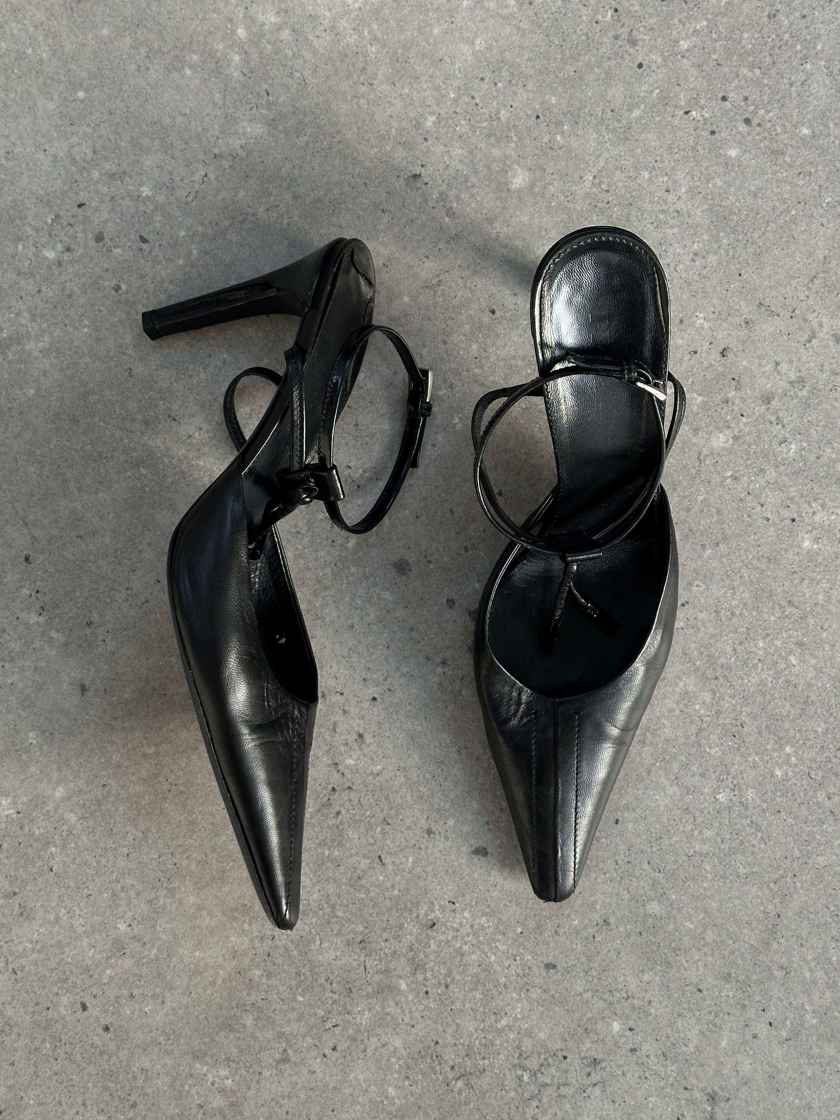 Prada pointed toe high heels in black leather, UK 7.5, EUR 40.5, with sleek stiletto design and elegant finish.