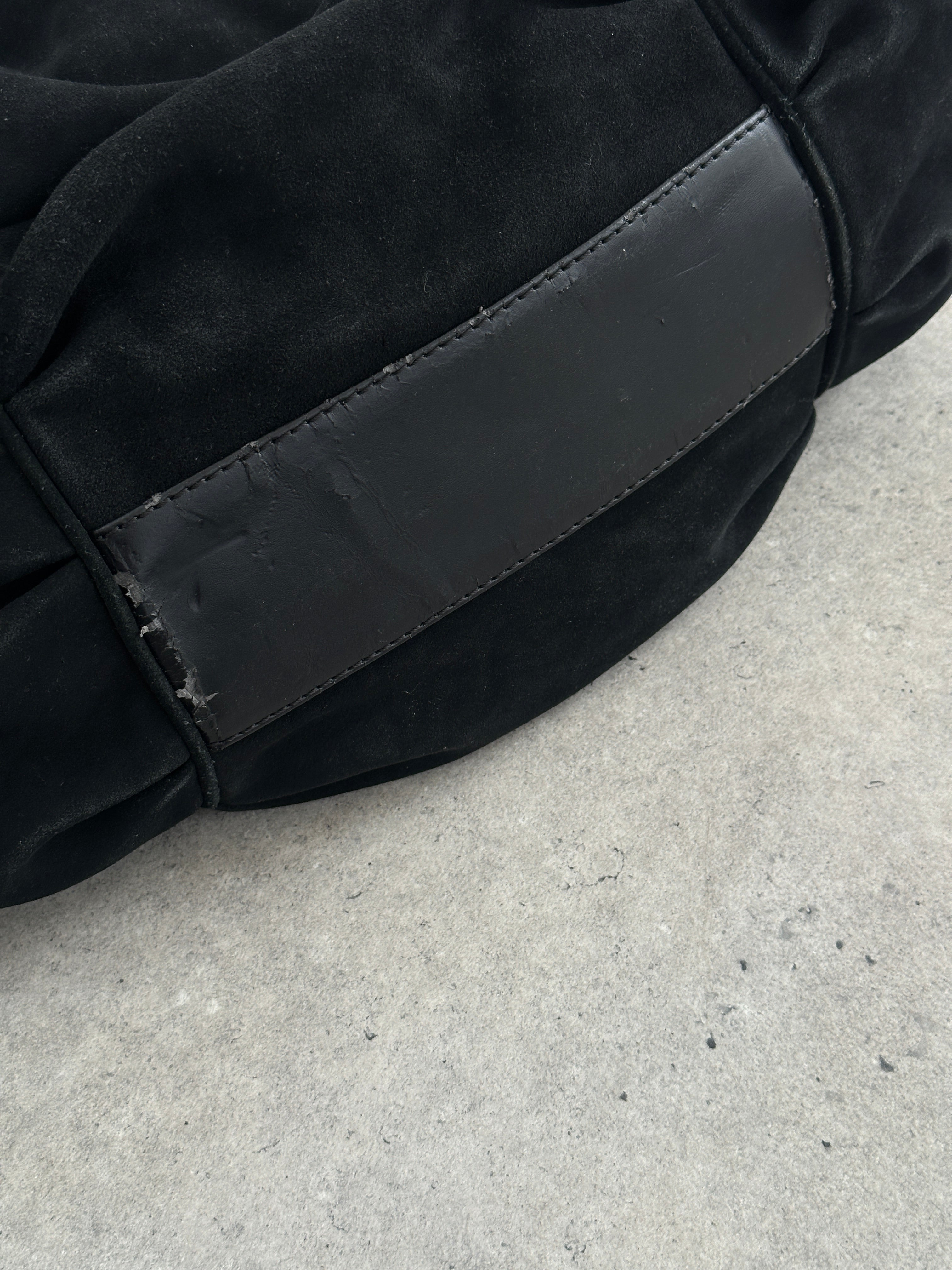 Armani Jeans suede ruched shoulder bag with a stylish design and shoulder strap, displayed against a neutral background.