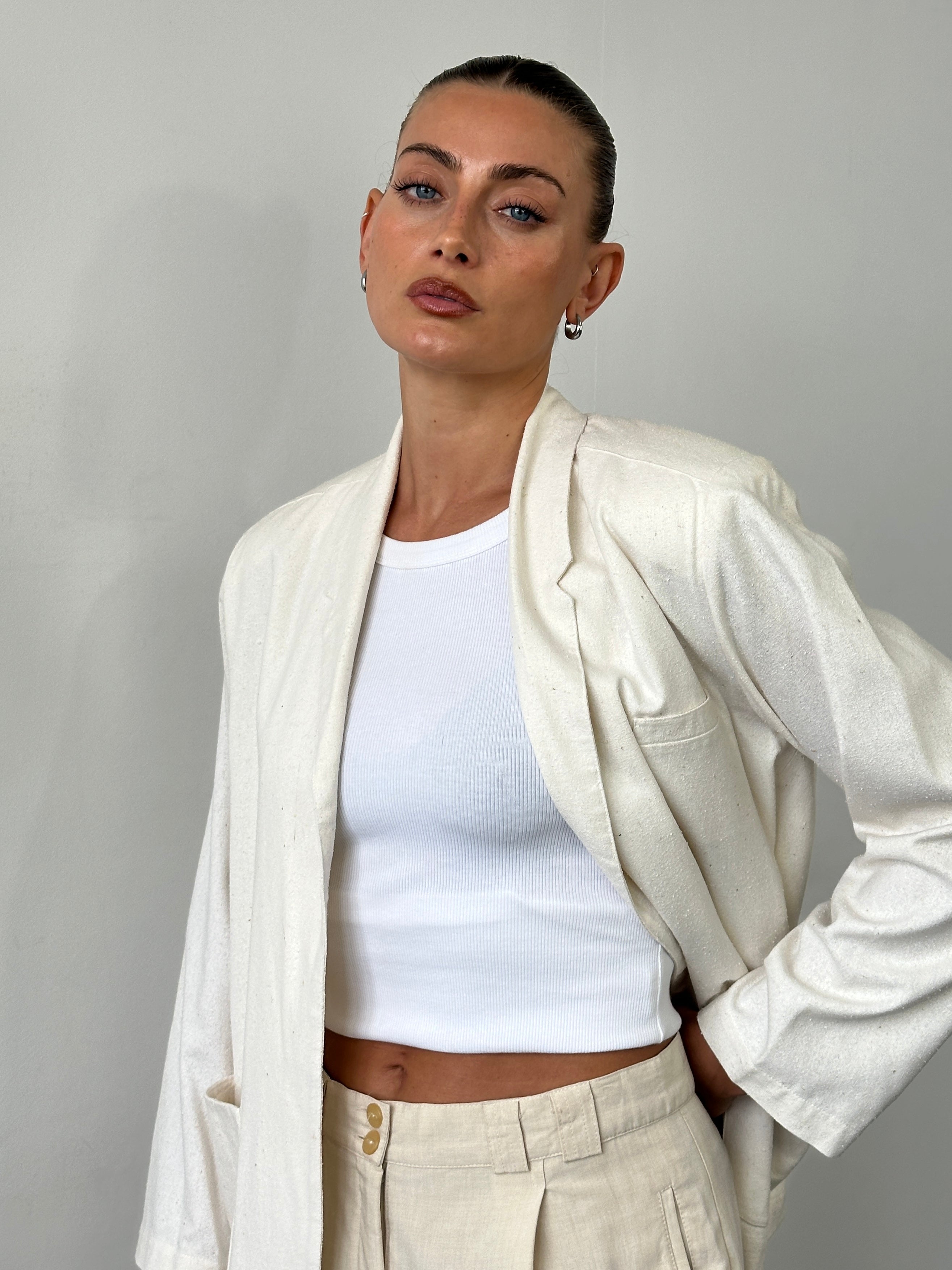 Vintage pure silk minimal blazer in S/M size, featuring sleek design and classic silhouette, displayed on a hanger.