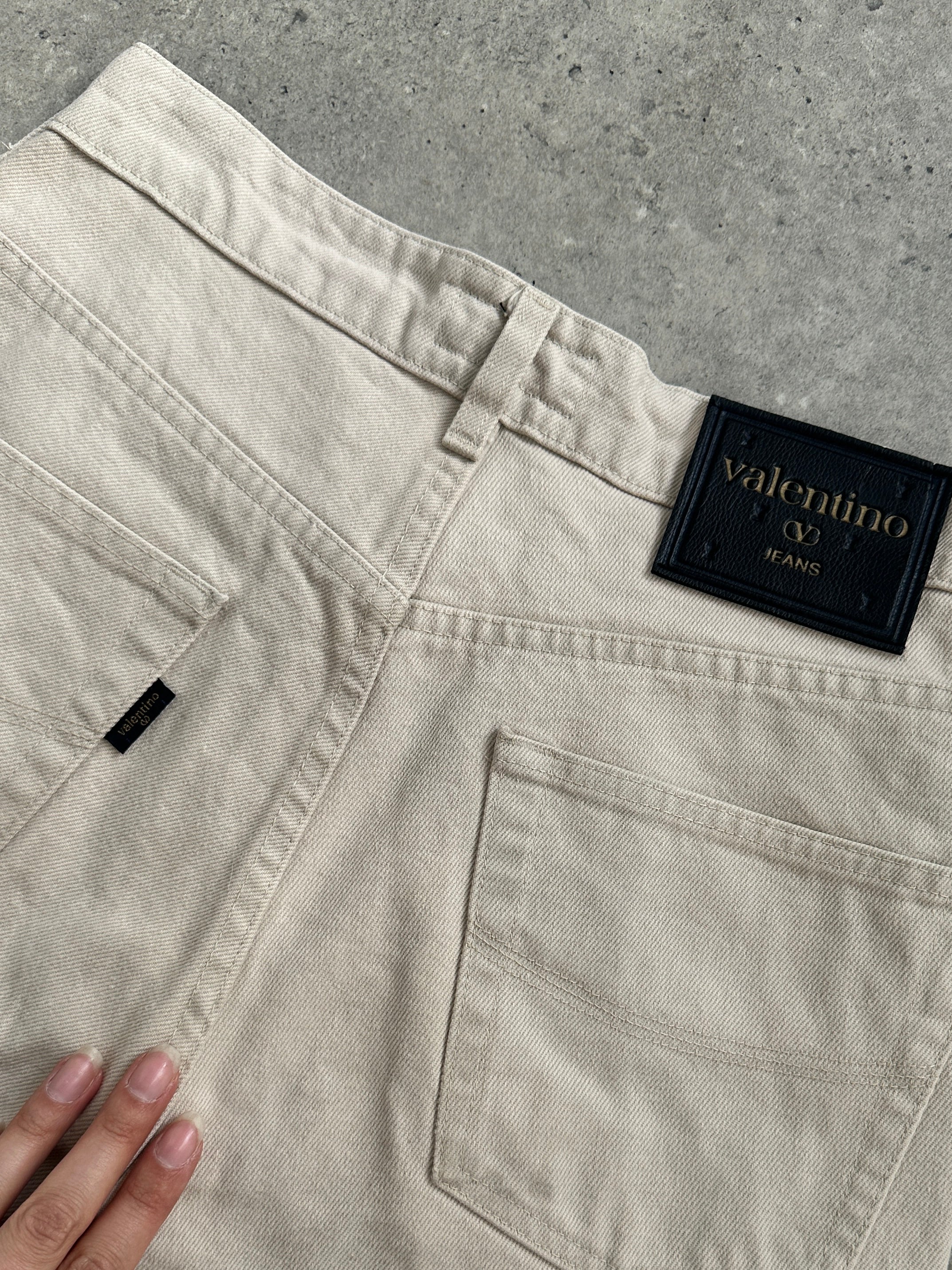 Valentino pure cotton high-waisted denim jeans in size W26, showcasing classic blue denim with a fitted waist and relaxed fit.