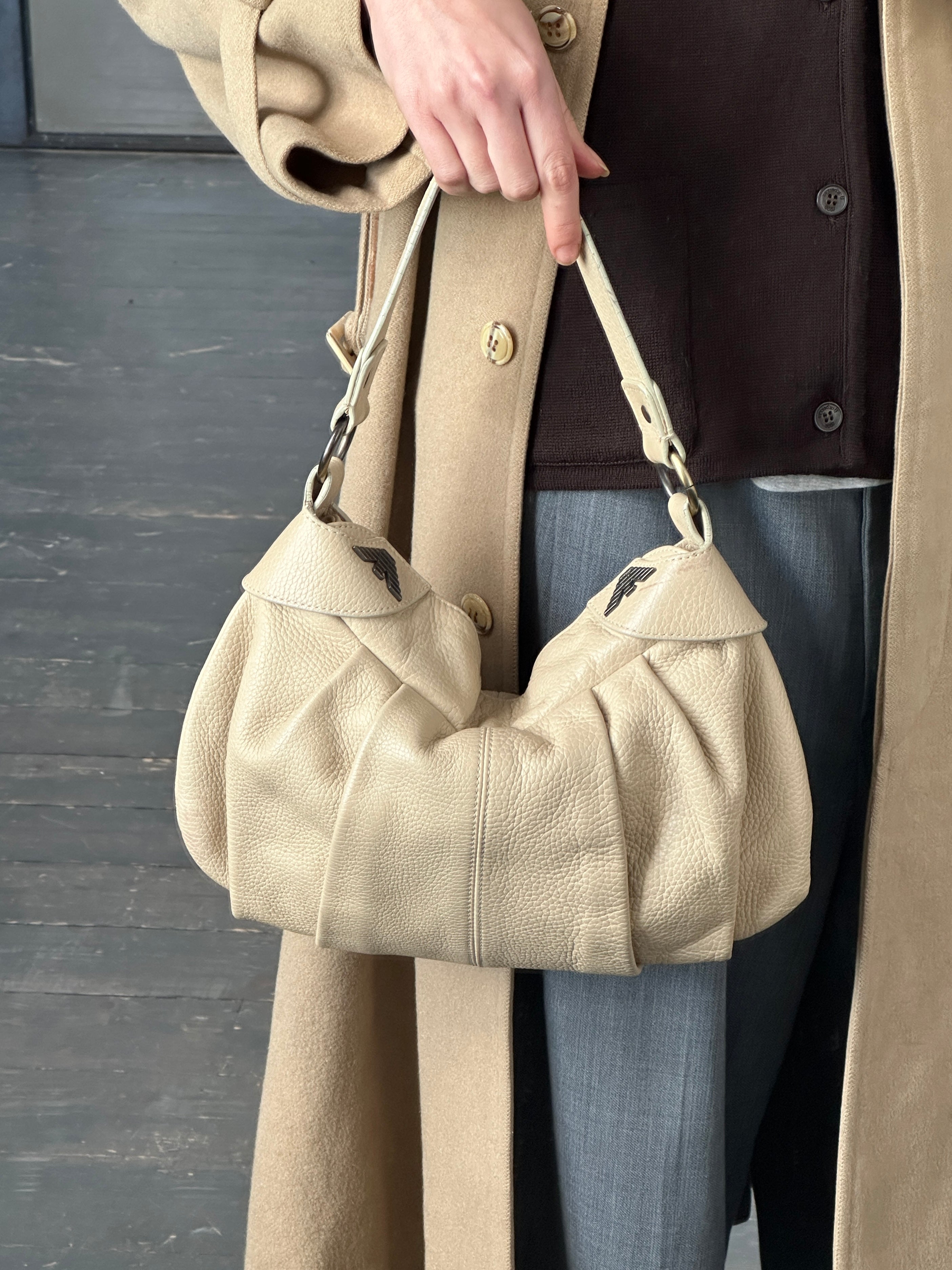Emporio Armani 2000s leather pleated shoulder bag with a structured design and shoulder strap, showcasing elegant craftsmanship.