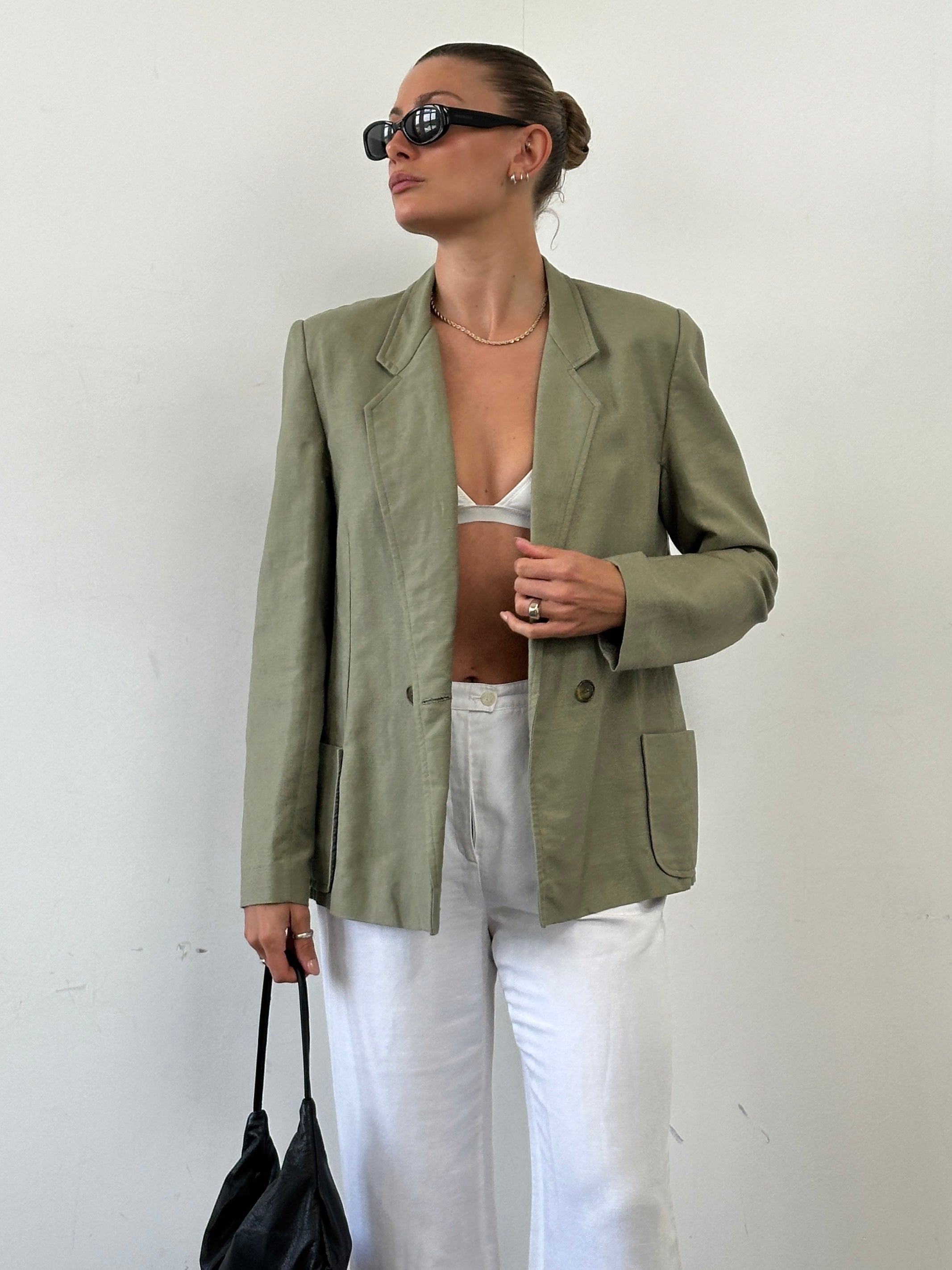 Vintage linen double-breasted blazer in size M, featuring classic tailored fit and vintage style, shown on a hanger.