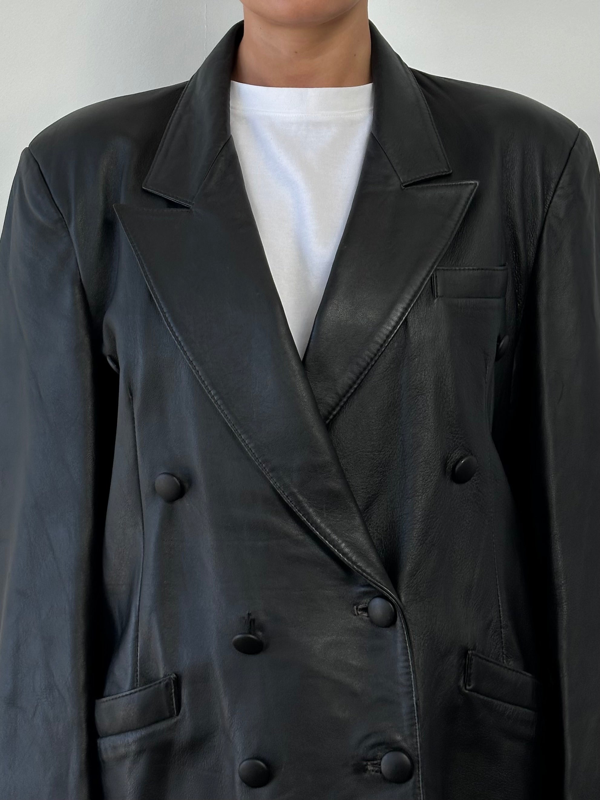 Vintage double-breasted leather blazer jacket in size large, featuring classic design and rich brown leather.