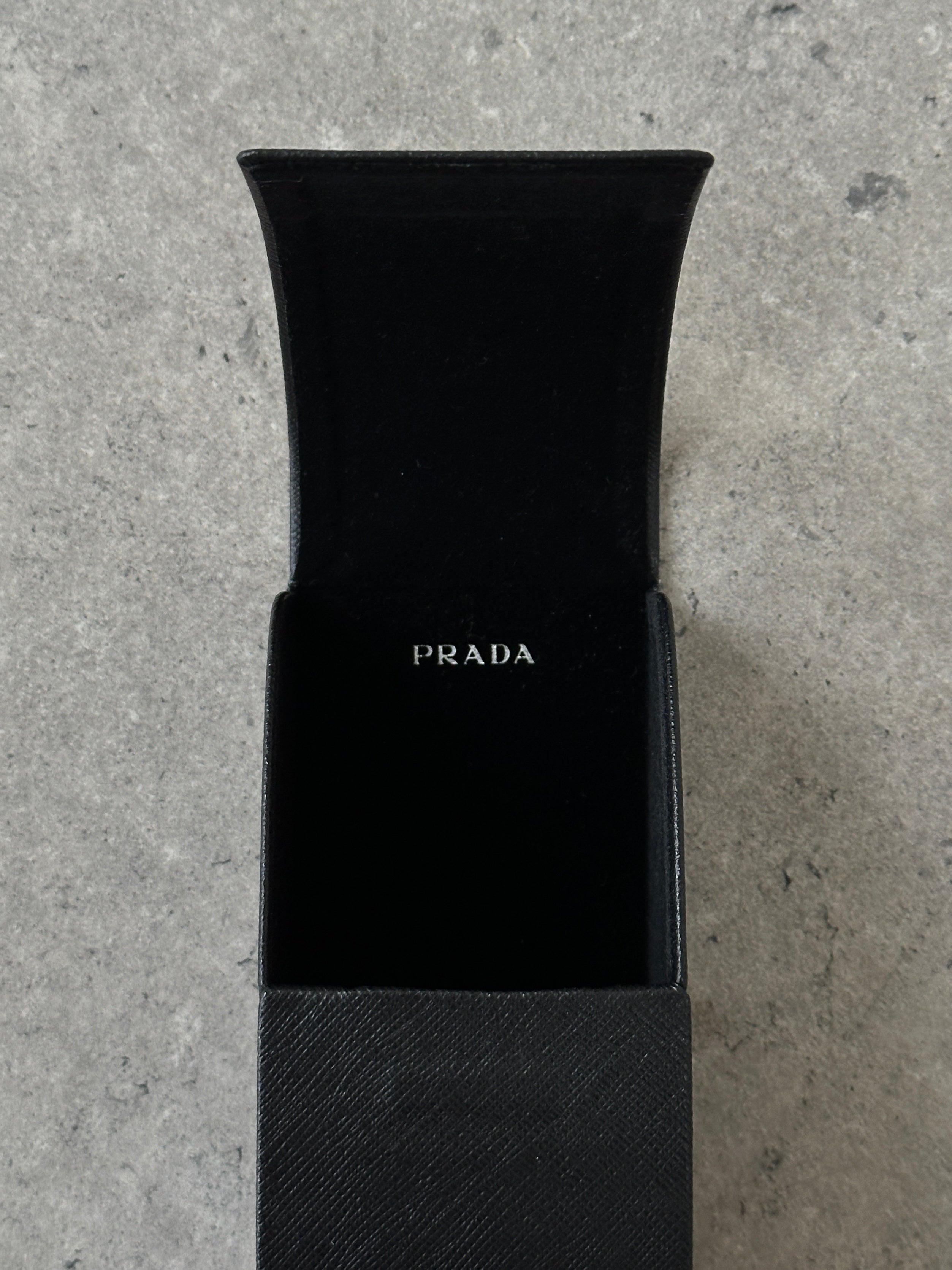 Prada tortoise shell round logo sunglasses with dark lenses, stylish and classic eyewear accessory.