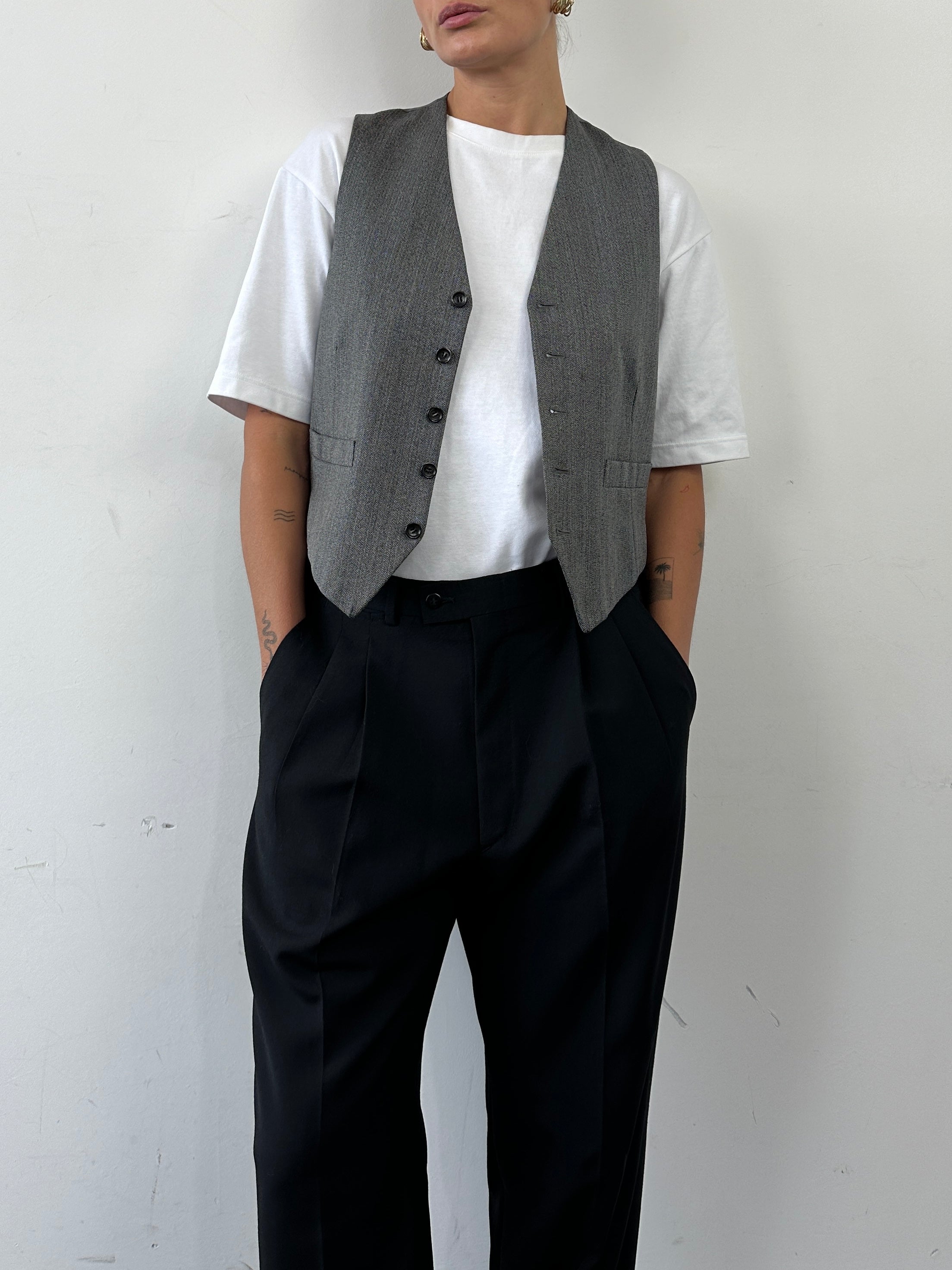 Vintage herringbone tailored waistcoat in size M, featuring classic design and button closure, suitable for formal or smart-casual wear.