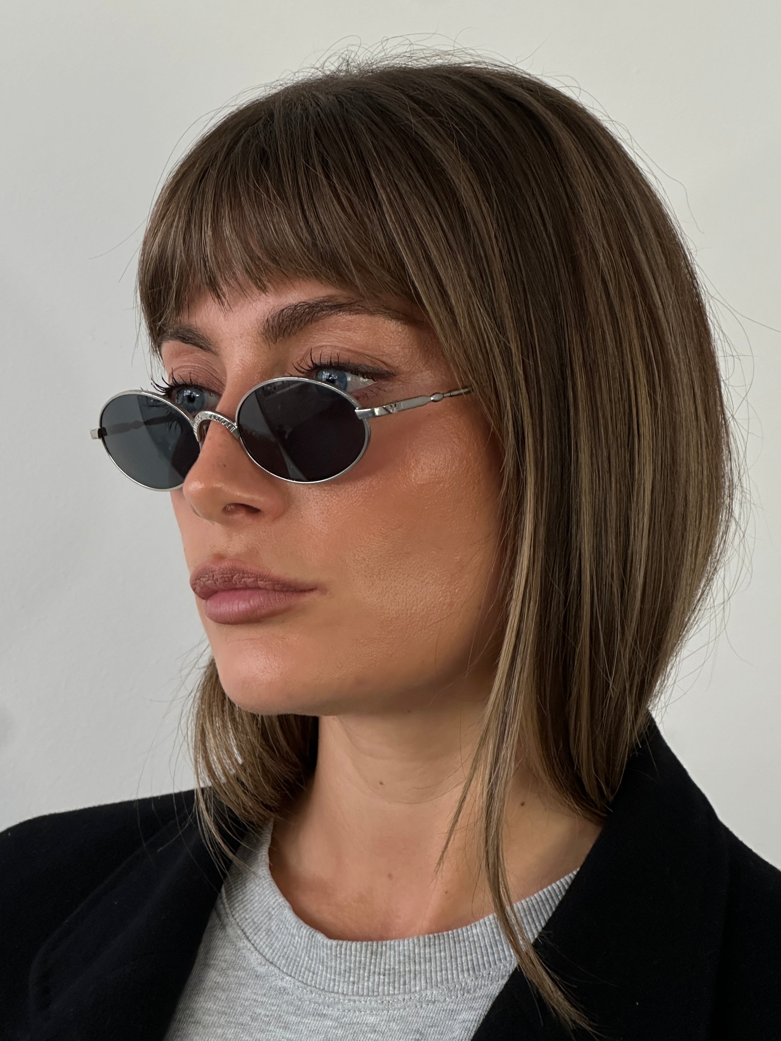Emporio Armani metal oval sunglasses with dark tinted lenses and sleek silver frames, stylish and modern eyewear.
