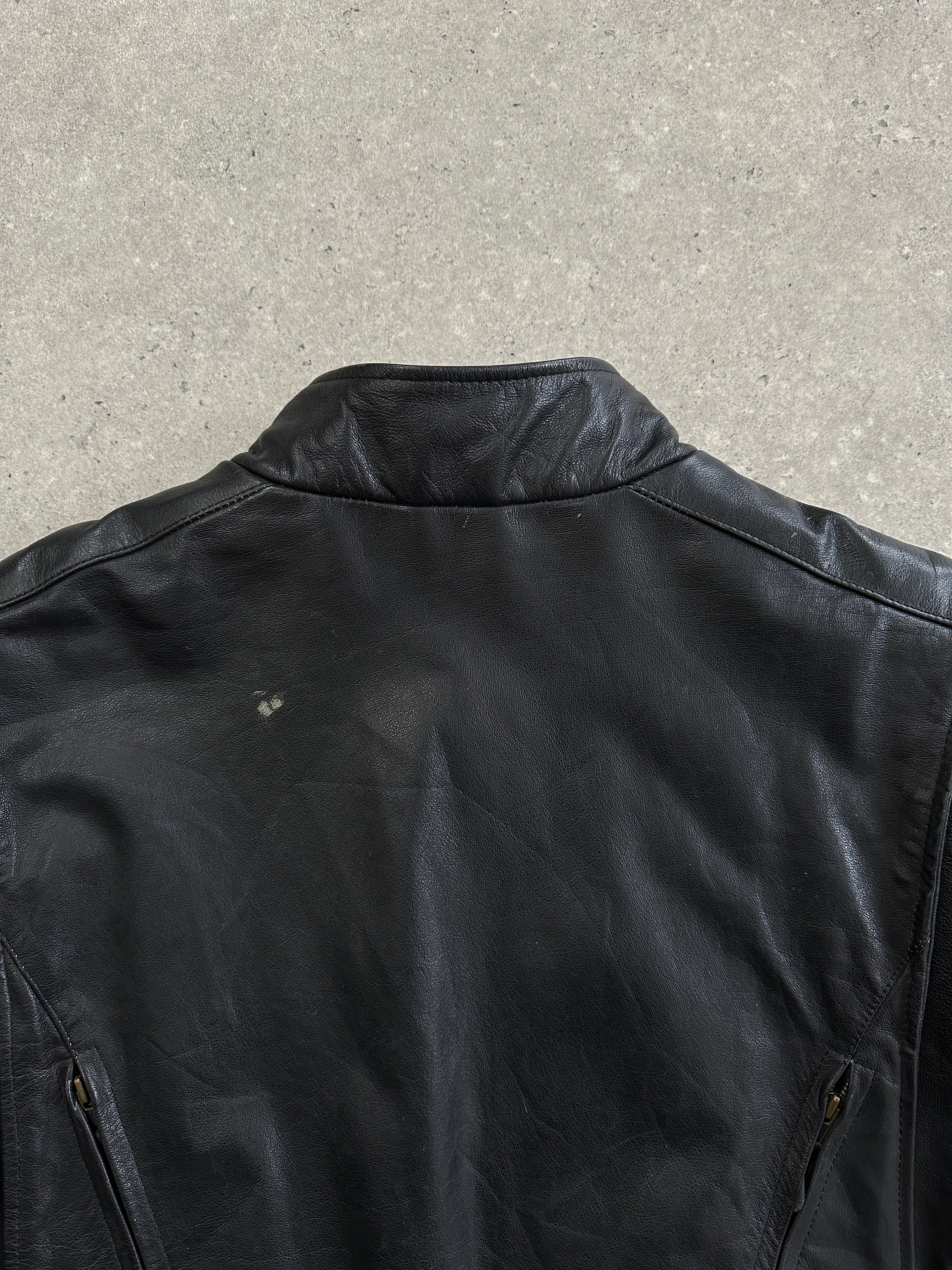Vintage leather motorcycle jacket in XL size, featuring classic design, sturdy zippers, and detailed stitching.
