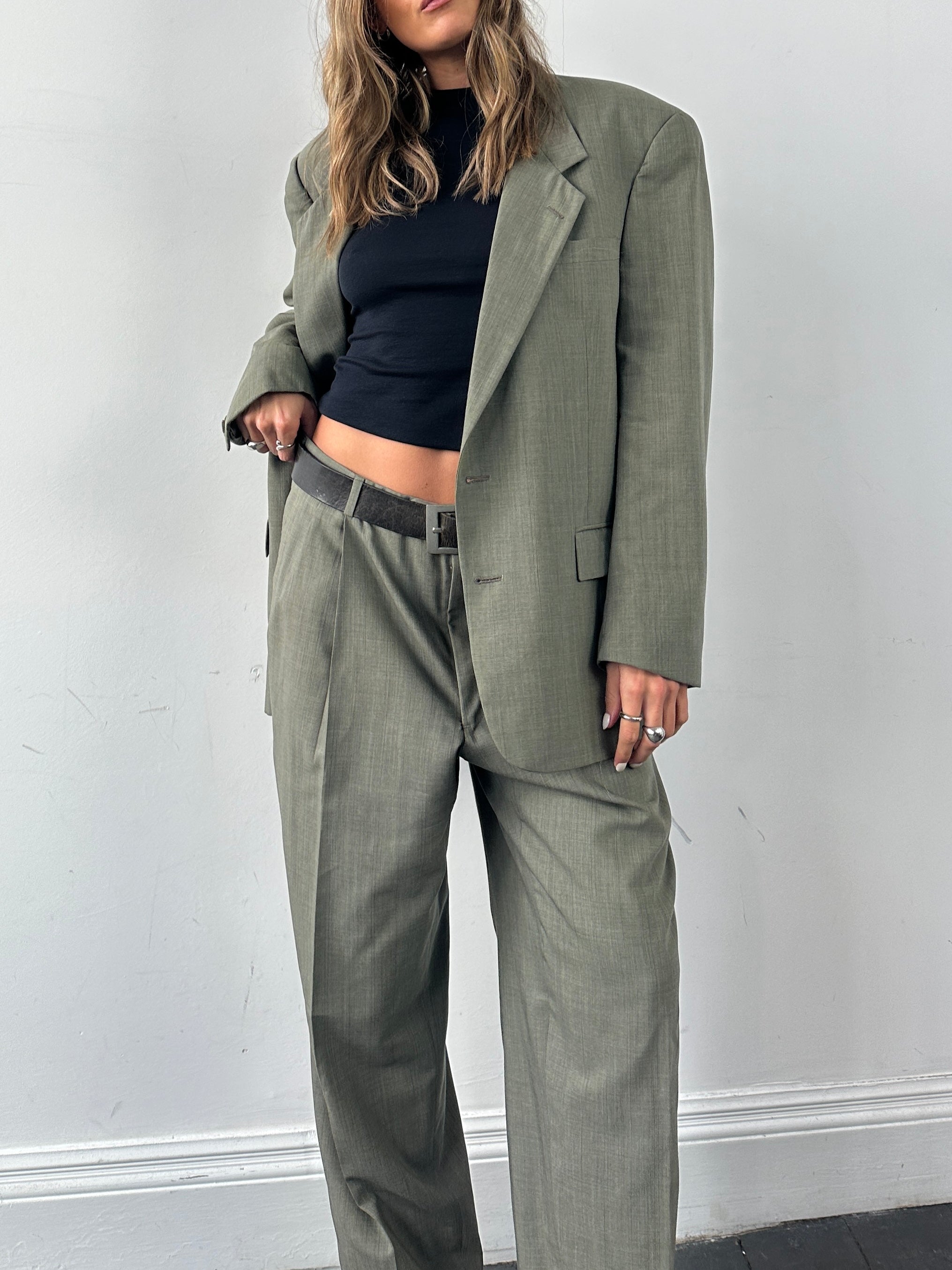 Christian Dior virgin wool jumpsuit in 42R/W32, single-breasted design, tailored fit, dark fabric with lapel collar and front buttons.