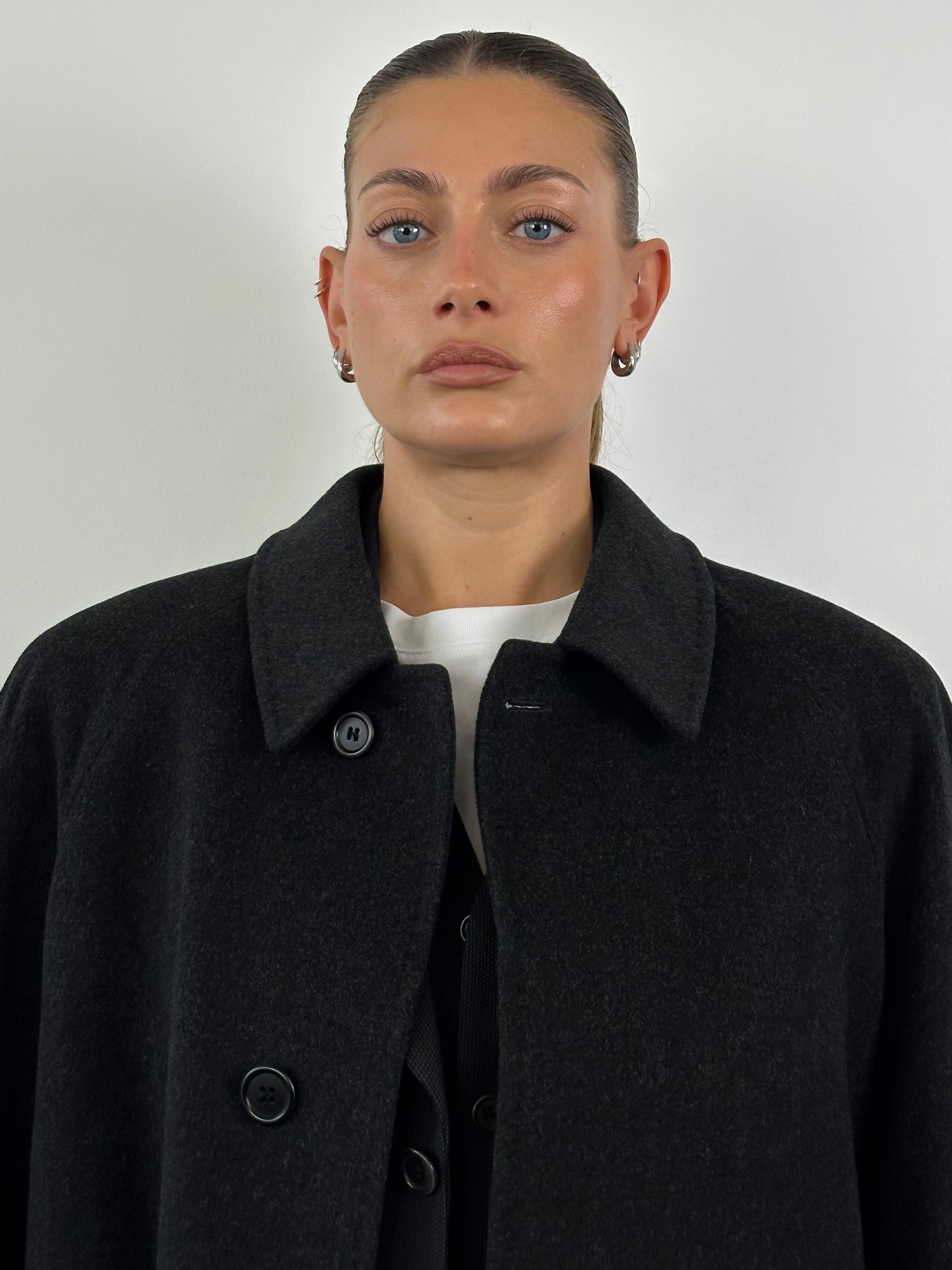 Loro Piana Viola XL coat made of pure virgin wool, featuring a concealed placket and tailored fit, displayed on a hanger.