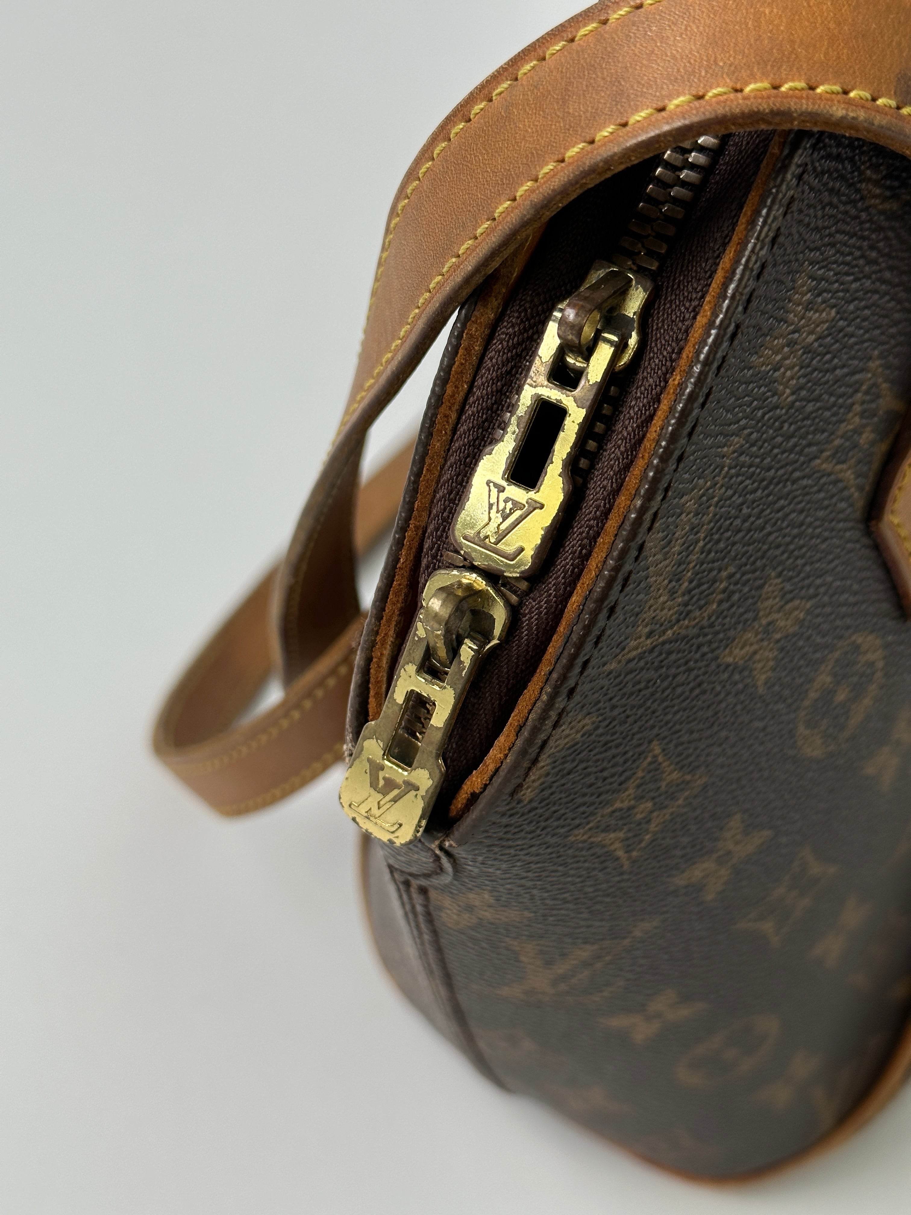 Louis Vuitton 1997 Ellipse Shoulder Bag showing its classic design and leather strap on a neutral background.