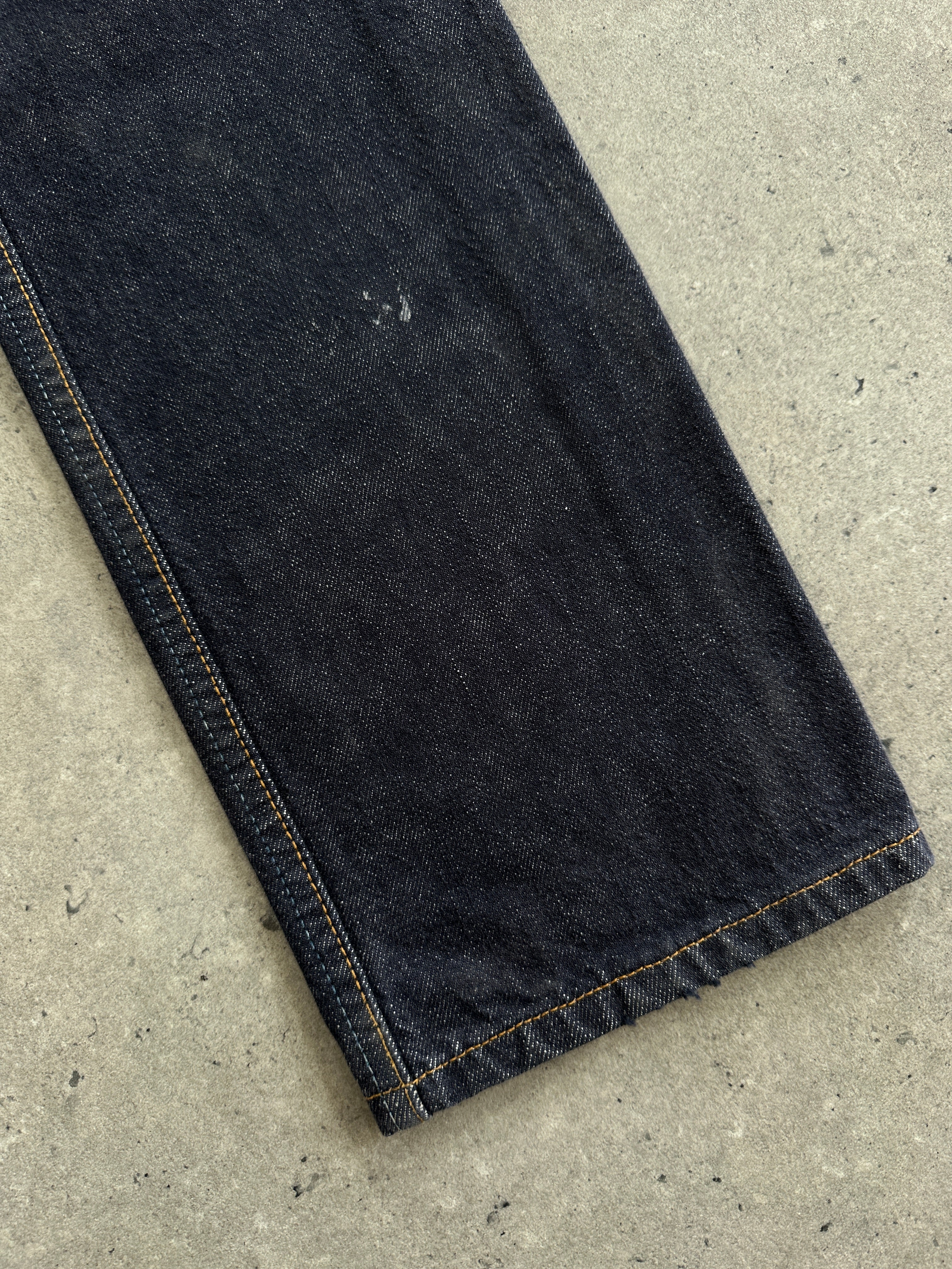 Levi’s 501 straight leg mid-waisted denim jeans in size W26, showing classic blue denim with subtle fading and stitching details.