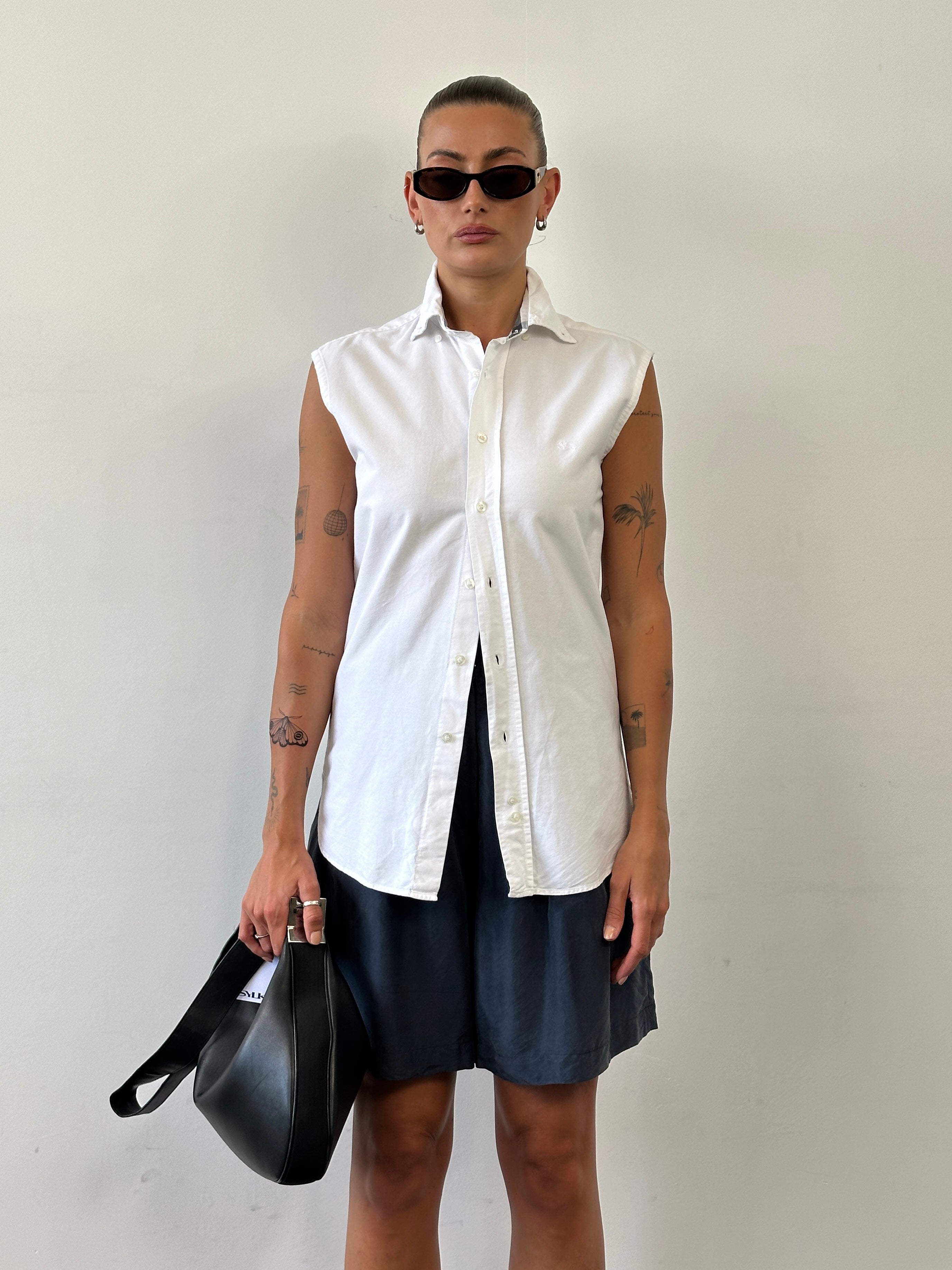 Burberry London pure cotton sleeveless shirt in size small, white with classic collar and button front, displayed flat.