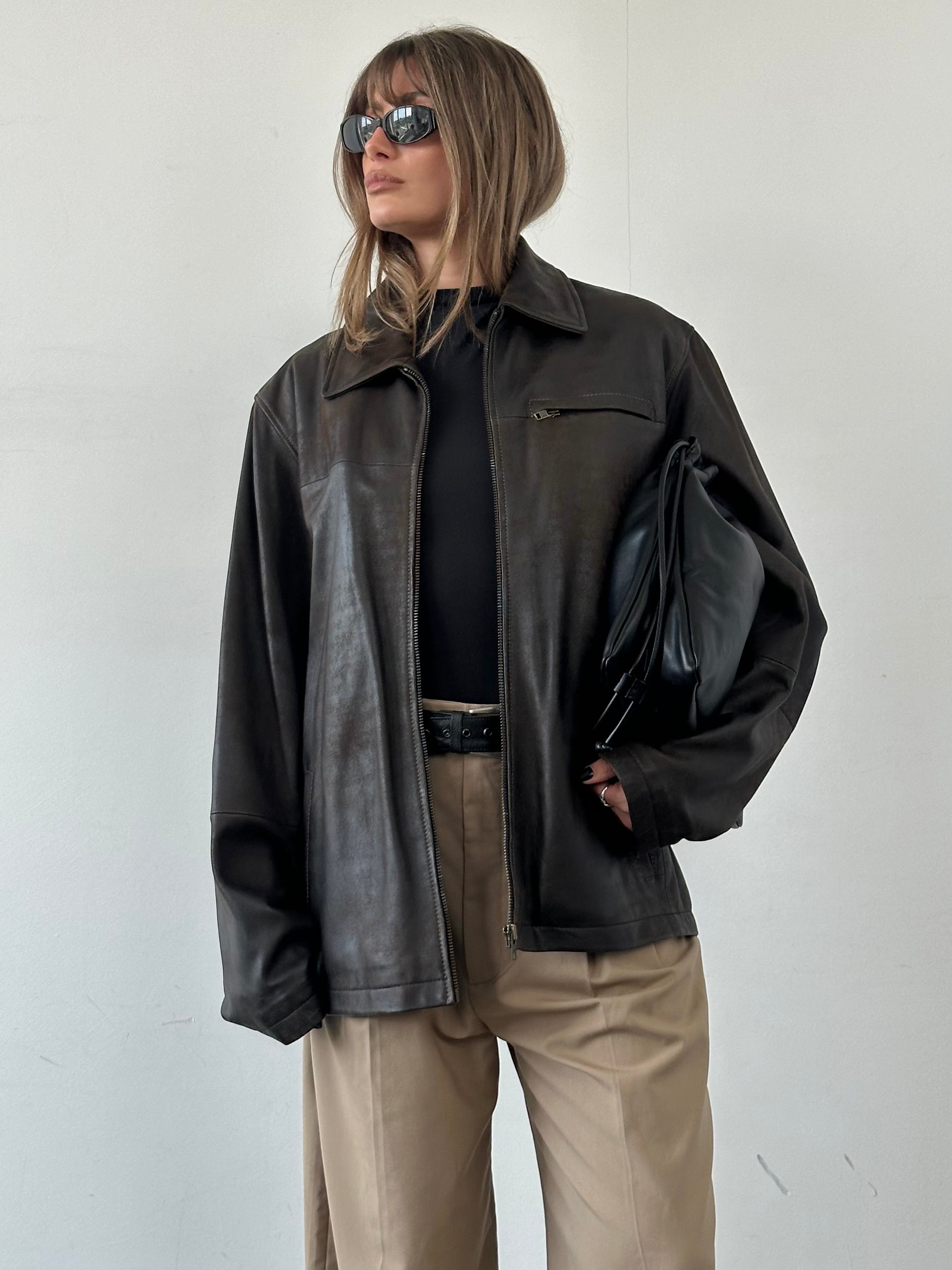 Vintage aged leather jacket in XL size, featuring a rugged, distressed look with classic styling and detailed stitching.