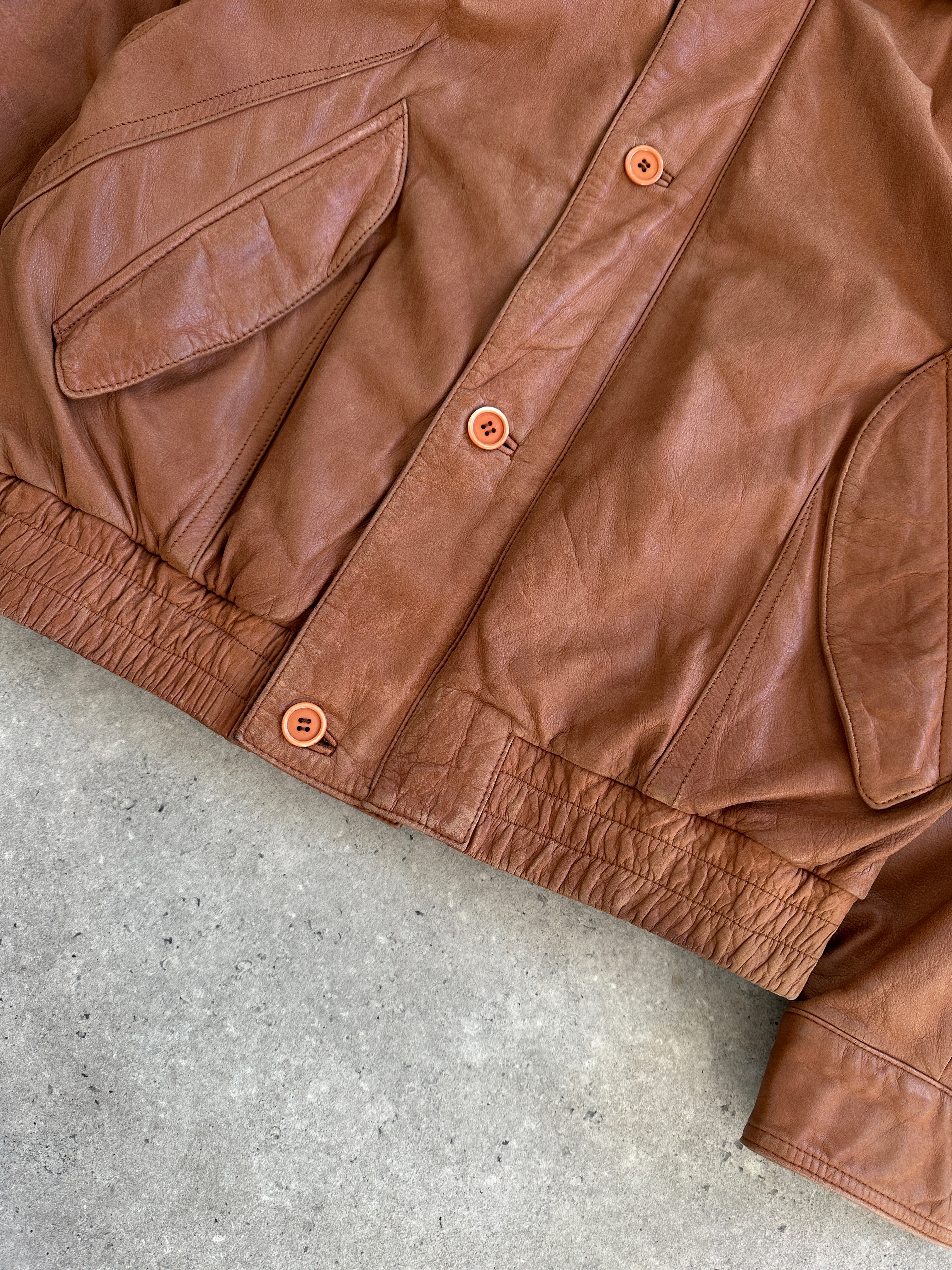 Vintage 1980s leather bomber jacket in size large, featuring classic design and aged leather details.