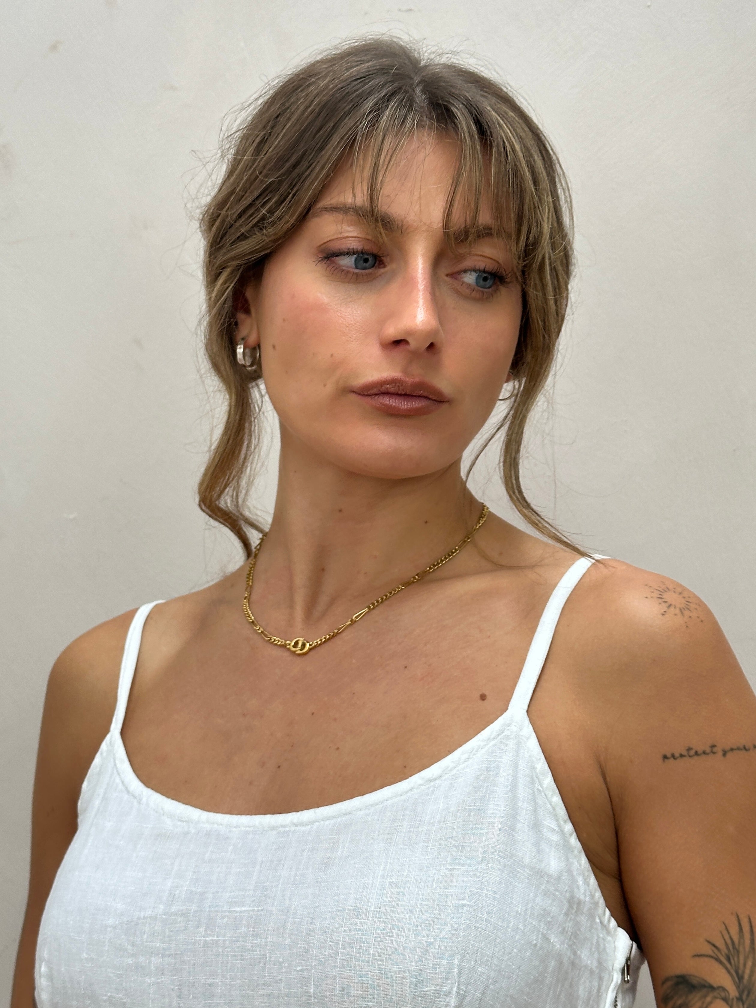 Christian Dior 18-inch gold plated logo pendant necklace with a sleek, polished finish and elegant design.