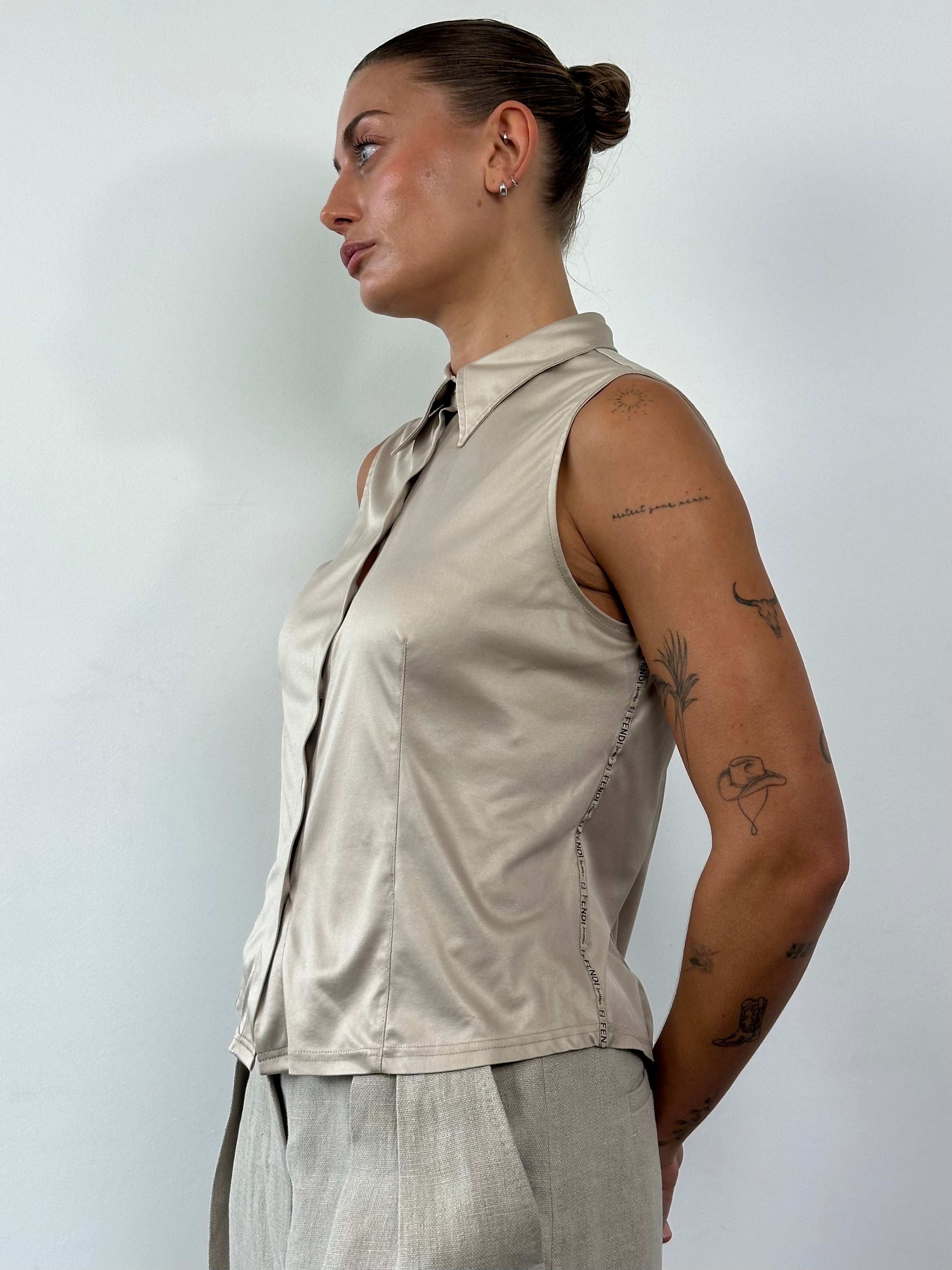 Fendi sleeveless satin logo shirt in size M/L, featuring a smooth fabric and iconic Fendi branding, displayed flat.