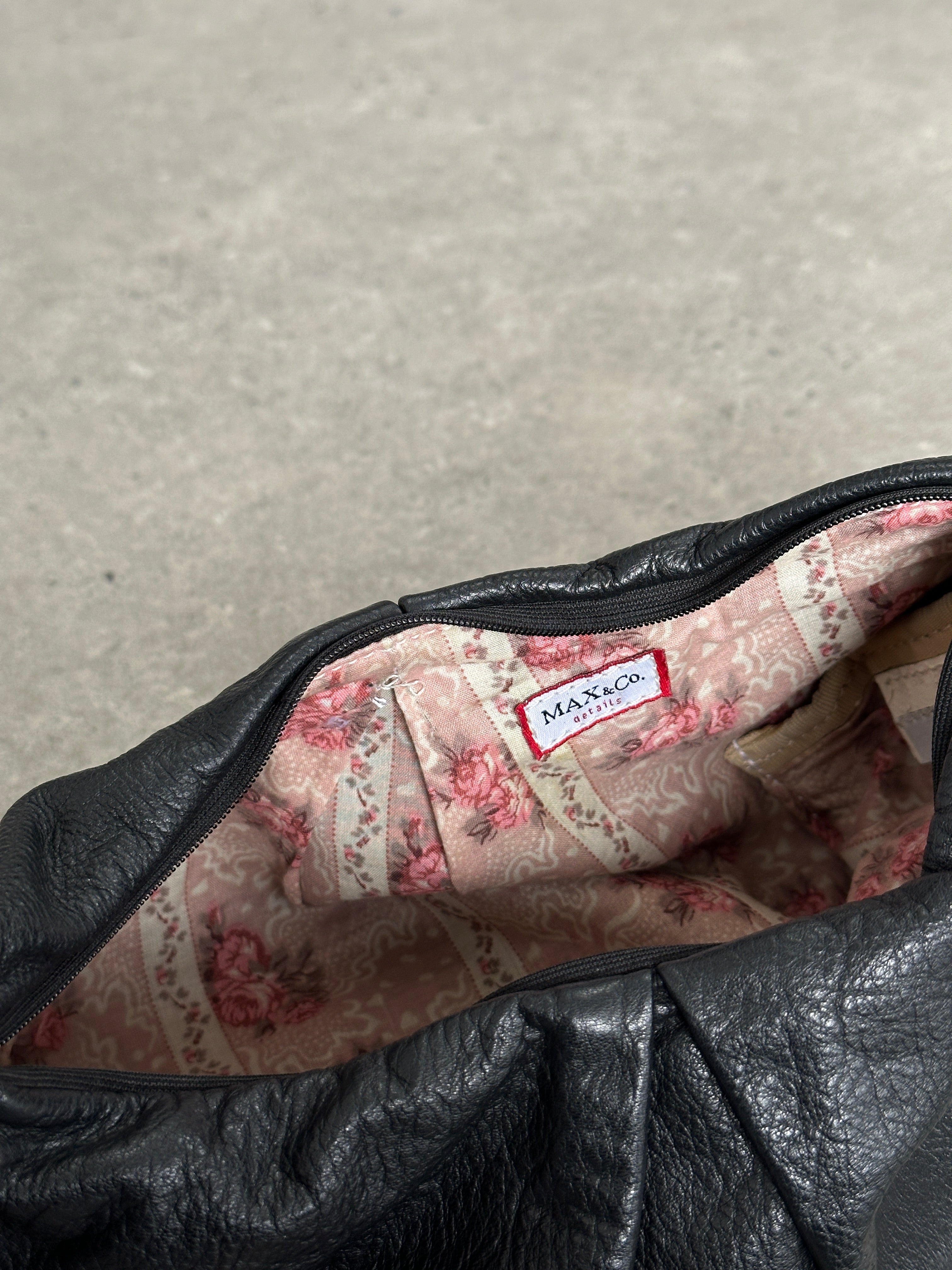 MAX & Co leather crescent shoulder bag with sleek design, featuring a smooth leather finish and a spacious interior.