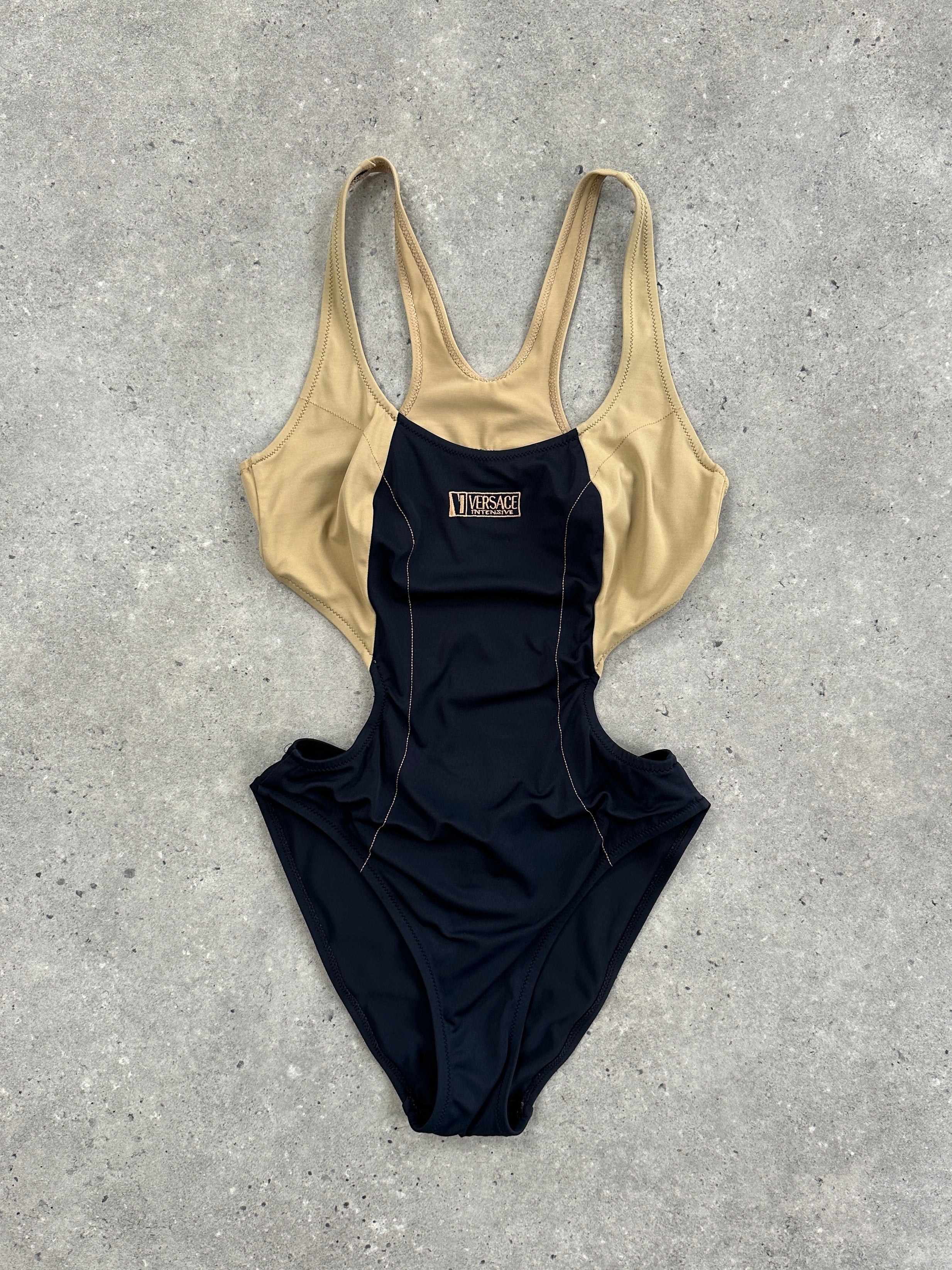 Versace Intensive 1990s high cut logo one-piece swimsuit, top view, showcasing bold design and signature branding in black and gold.