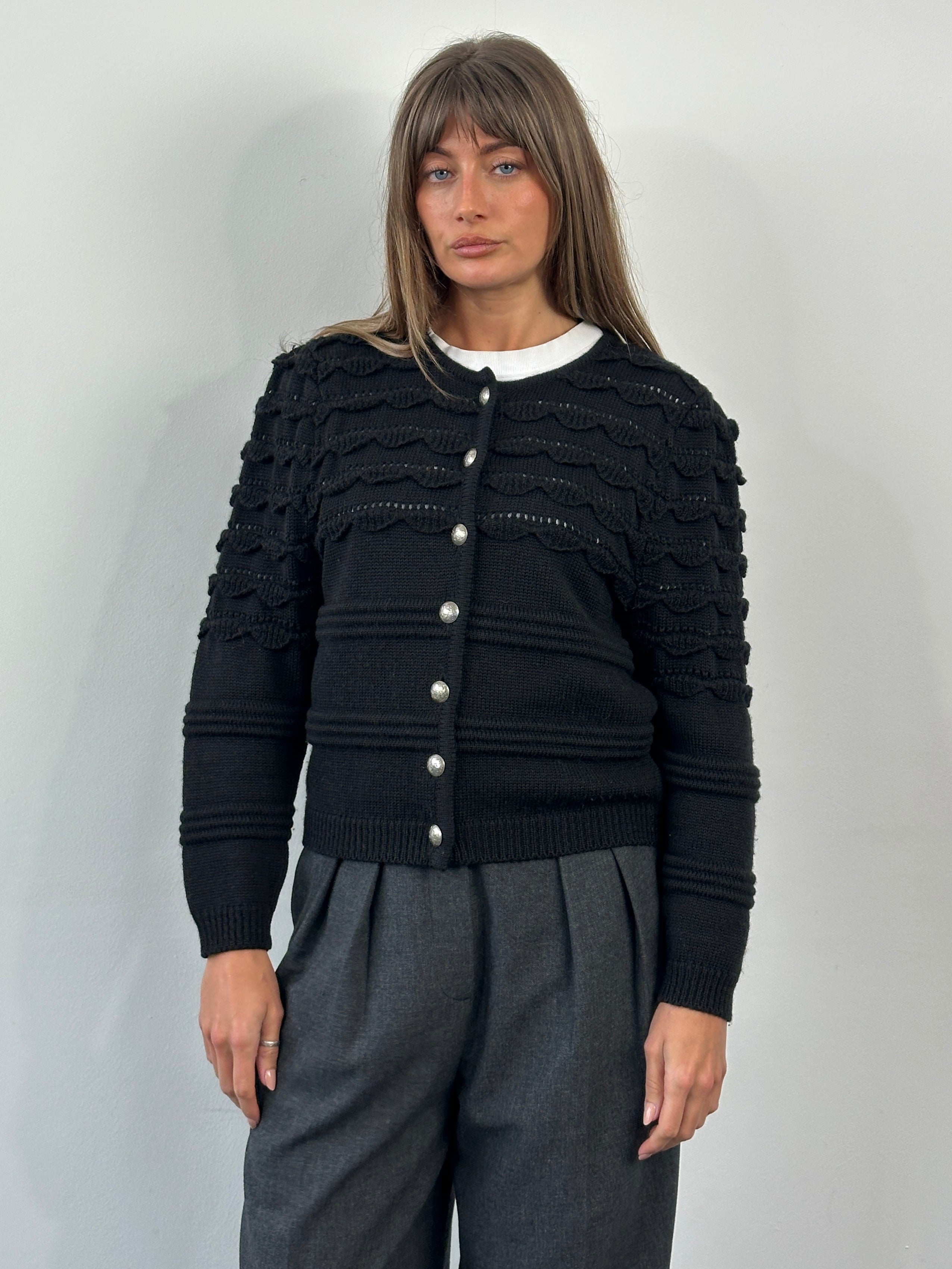 Vintage 1990s pure wool knitted cardigan in size M, featuring a classic design and textured knit pattern.