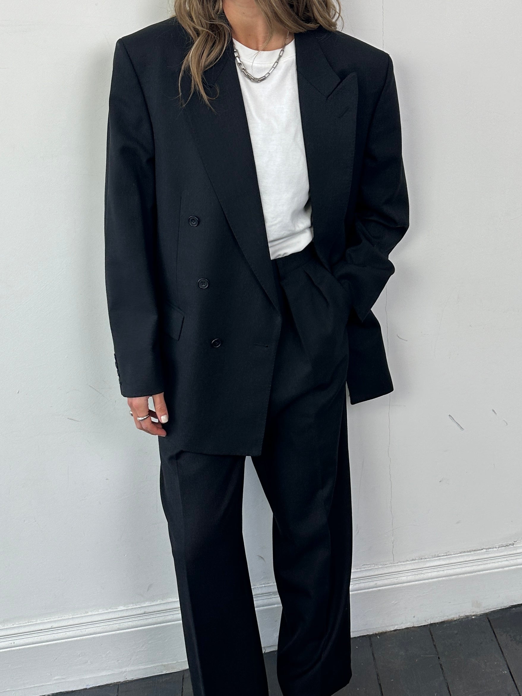 Christian Dior wool double-breasted jumpsuit in size 42R/W30, featuring a tailored fit and classic design with lapel collar.