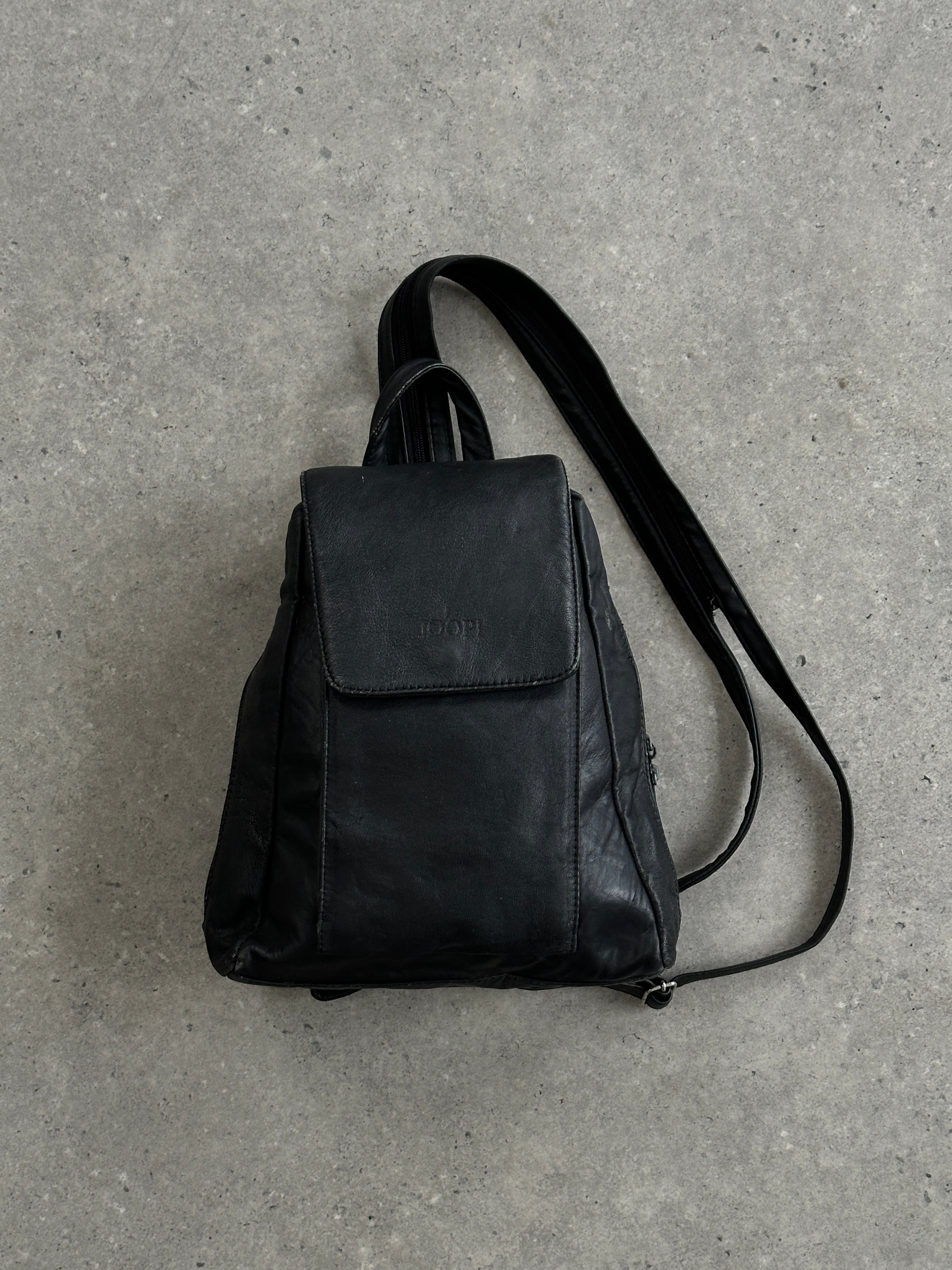 Vintage faux leather rucksack bag with adjustable straps and front pockets, stylish and functional for everyday use.