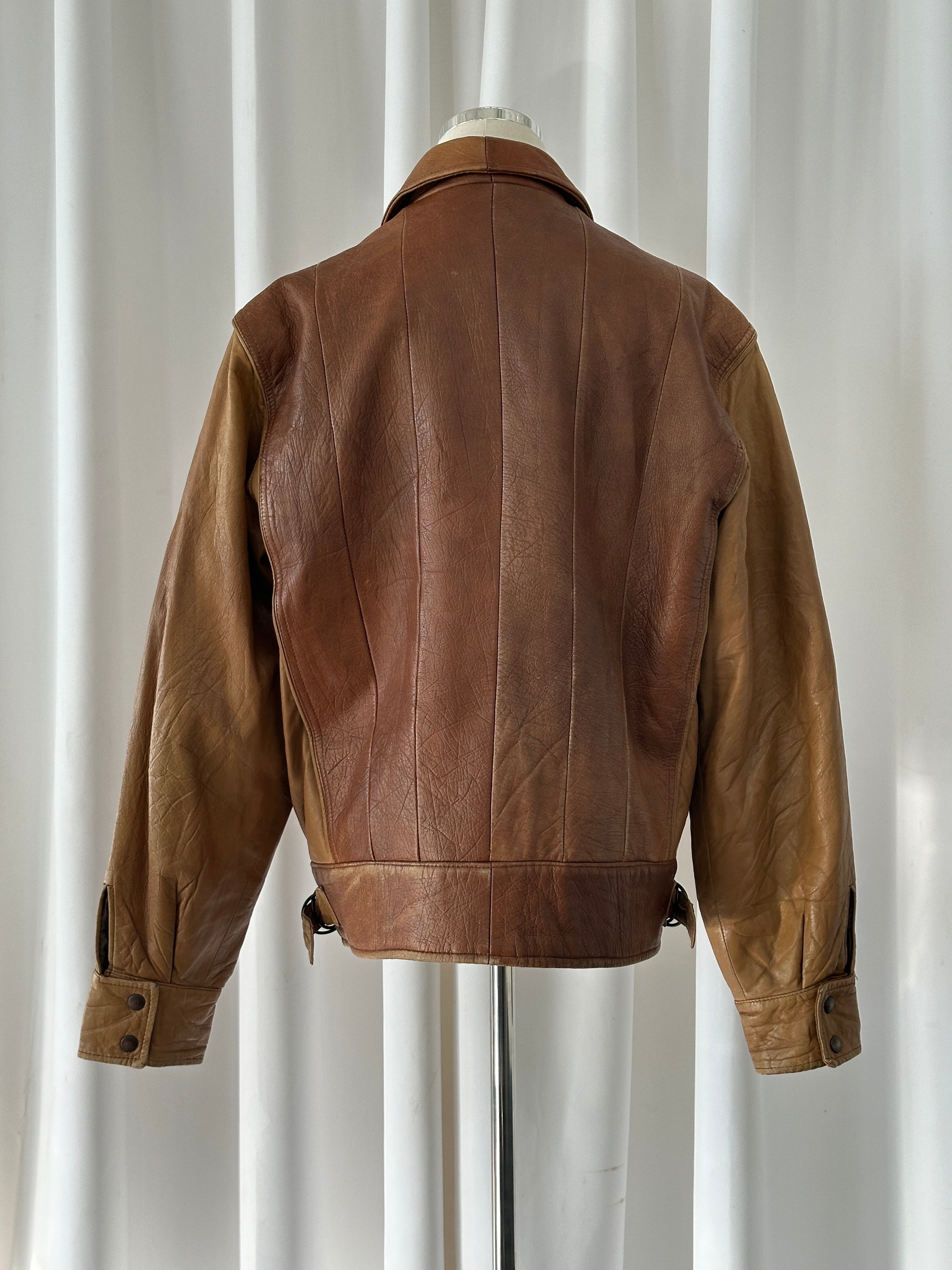 Vintage Italian leather bomber jacket from the 1980s, featuring classic design and worn-in leather texture in size M/L.