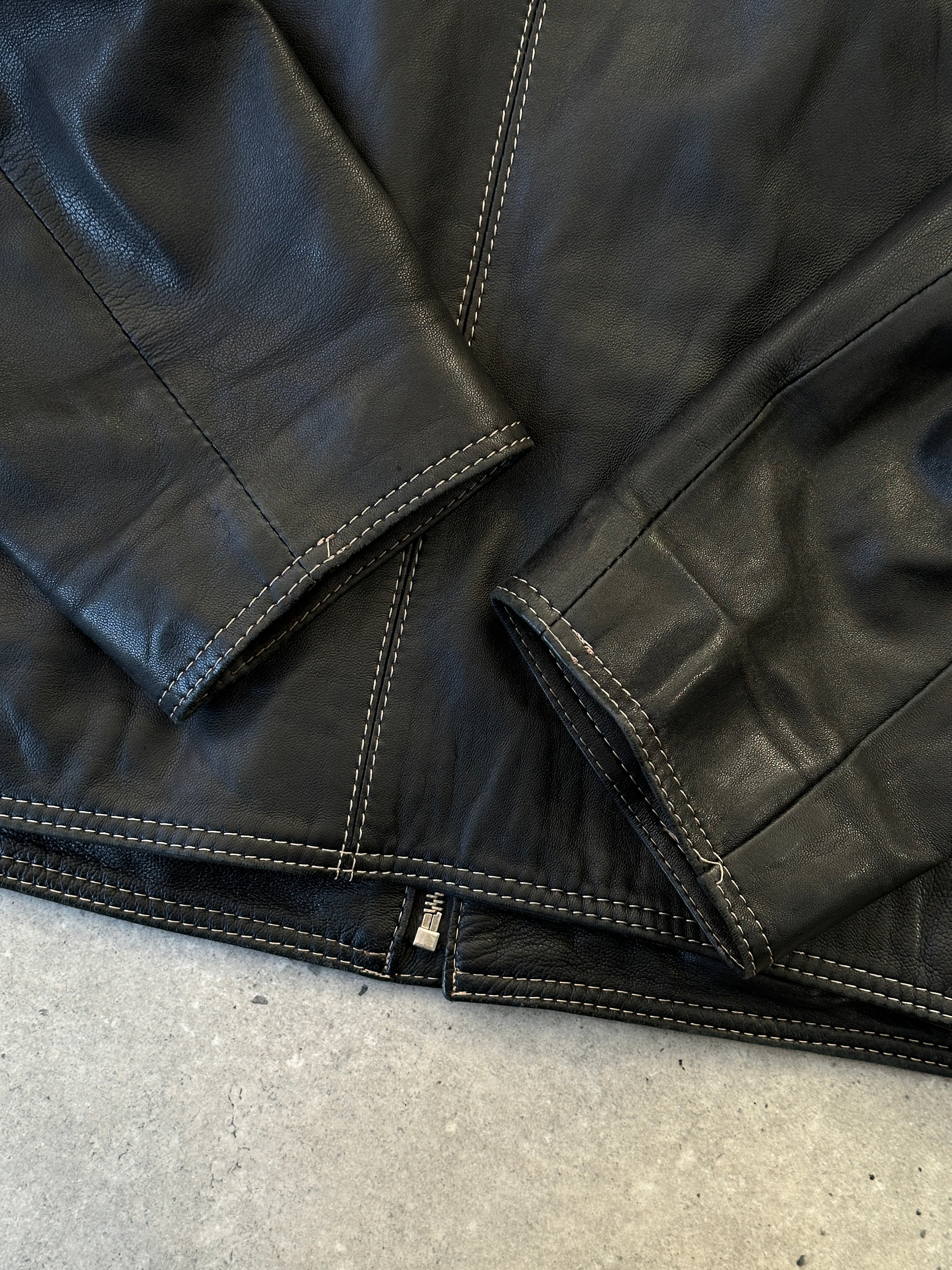 Vintage contrast stitch leather jacket, size M, featuring classic design and detailed stitching, displayed on a neutral background.