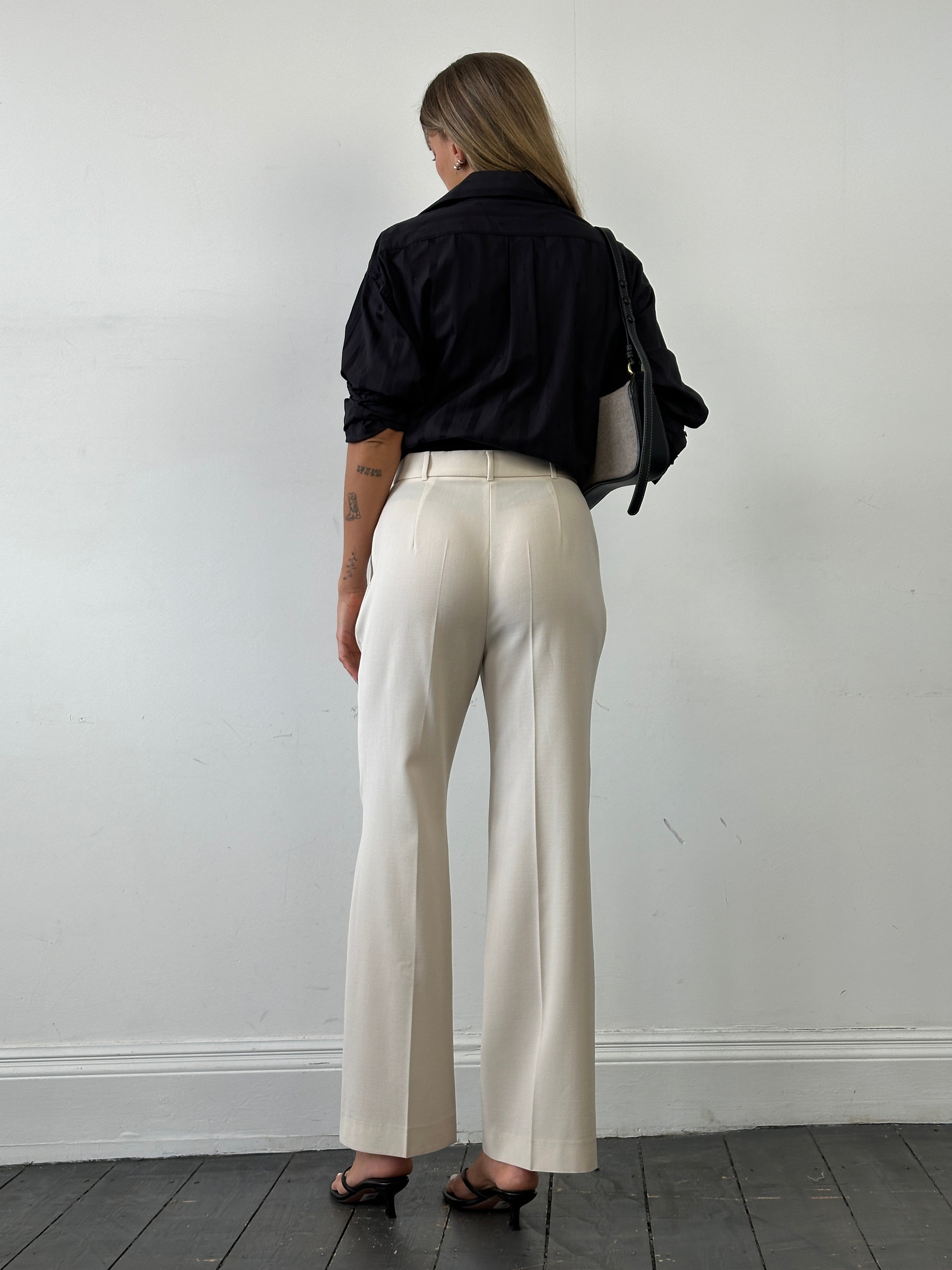 Max Mara high-waisted tailored wool trousers in dark fabric, front view showing sleek, structured design and classic fit.