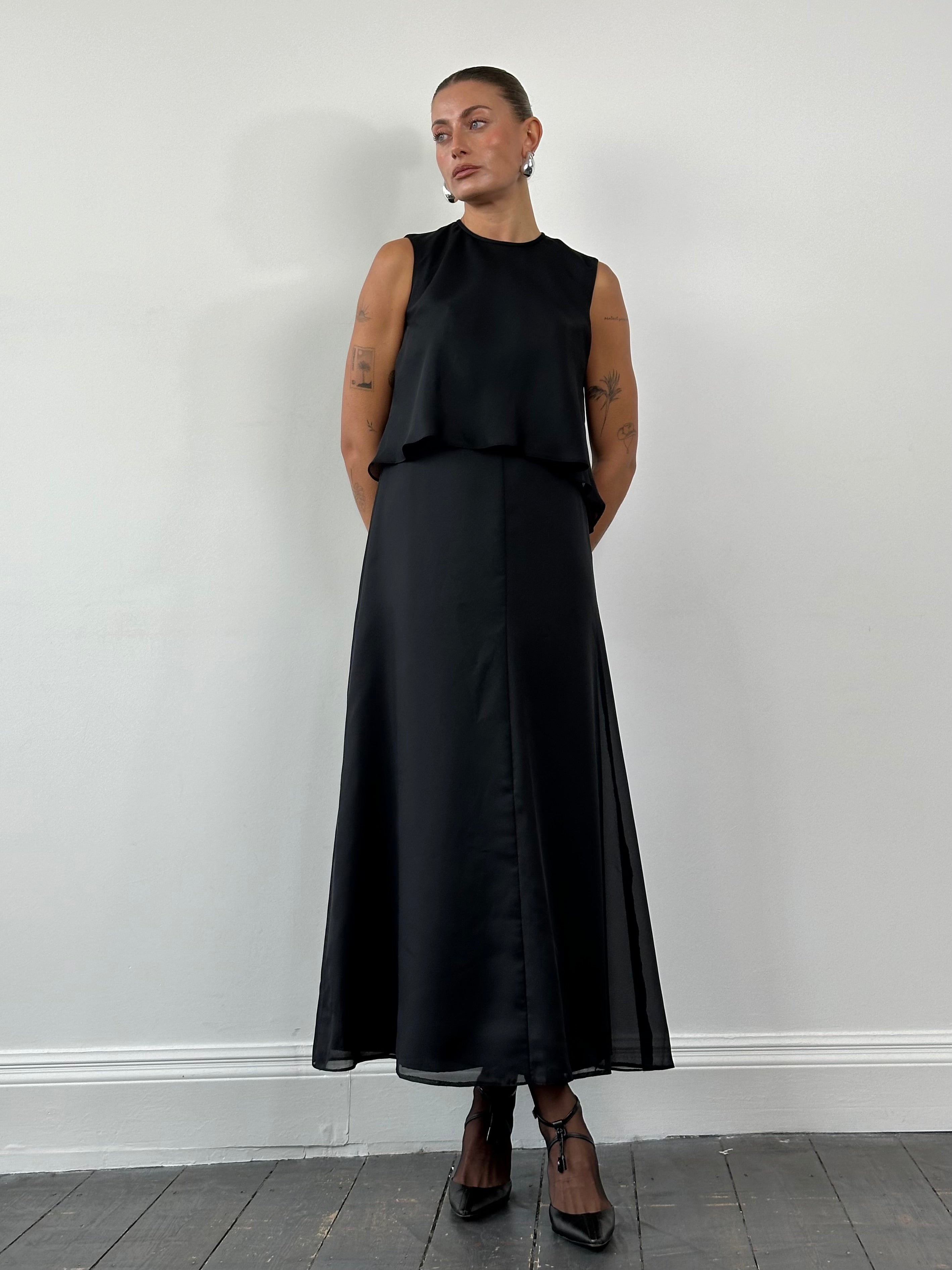 Vintage 1990s double layered maxi dress in black and floral print, featuring a flowing silhouette and midi-length design.