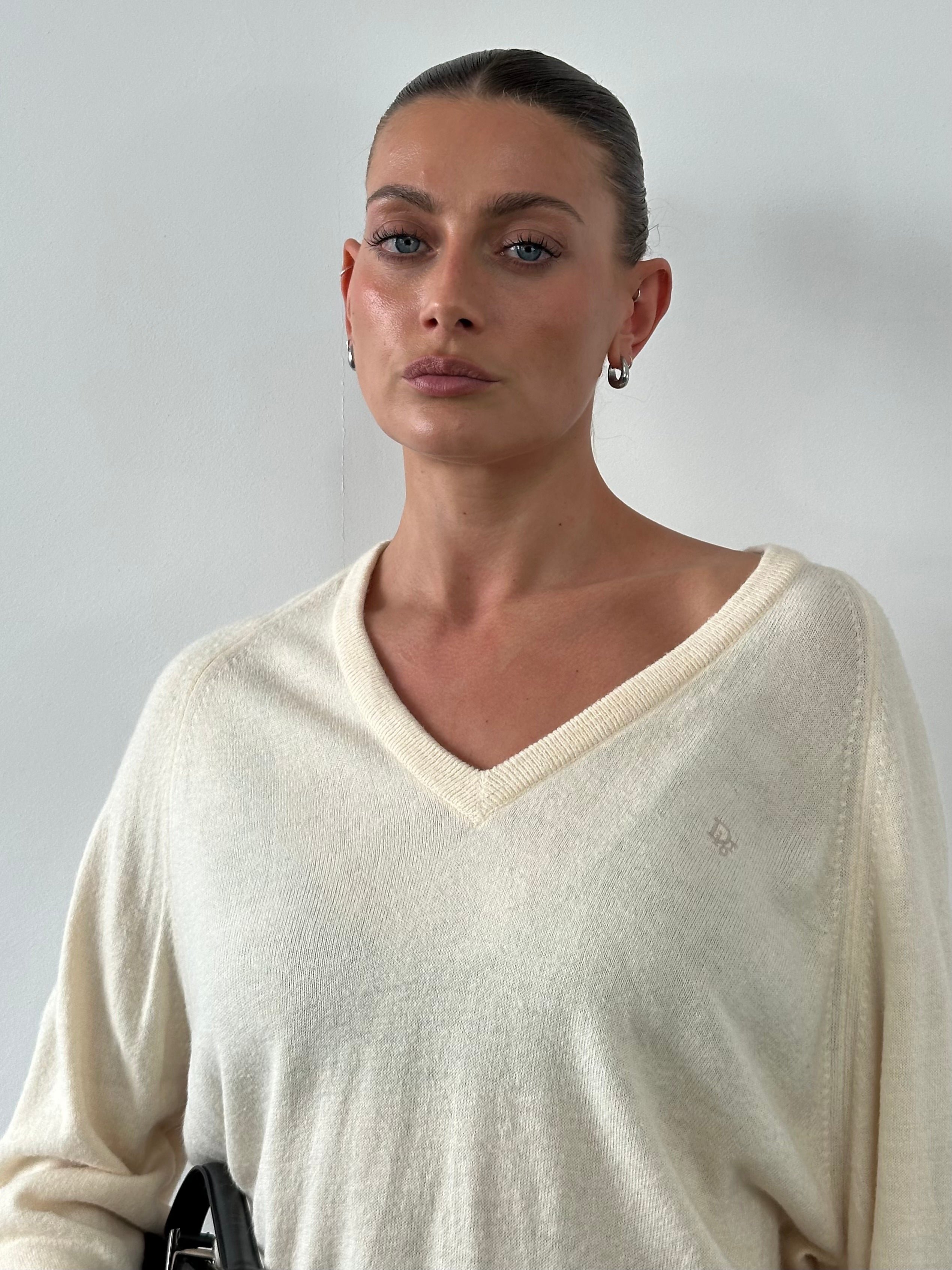 Christian Dior 1980s V-neck logo knitted jumper, L/XL, featuring a classic design and brand logo, displayed on a neutral background.