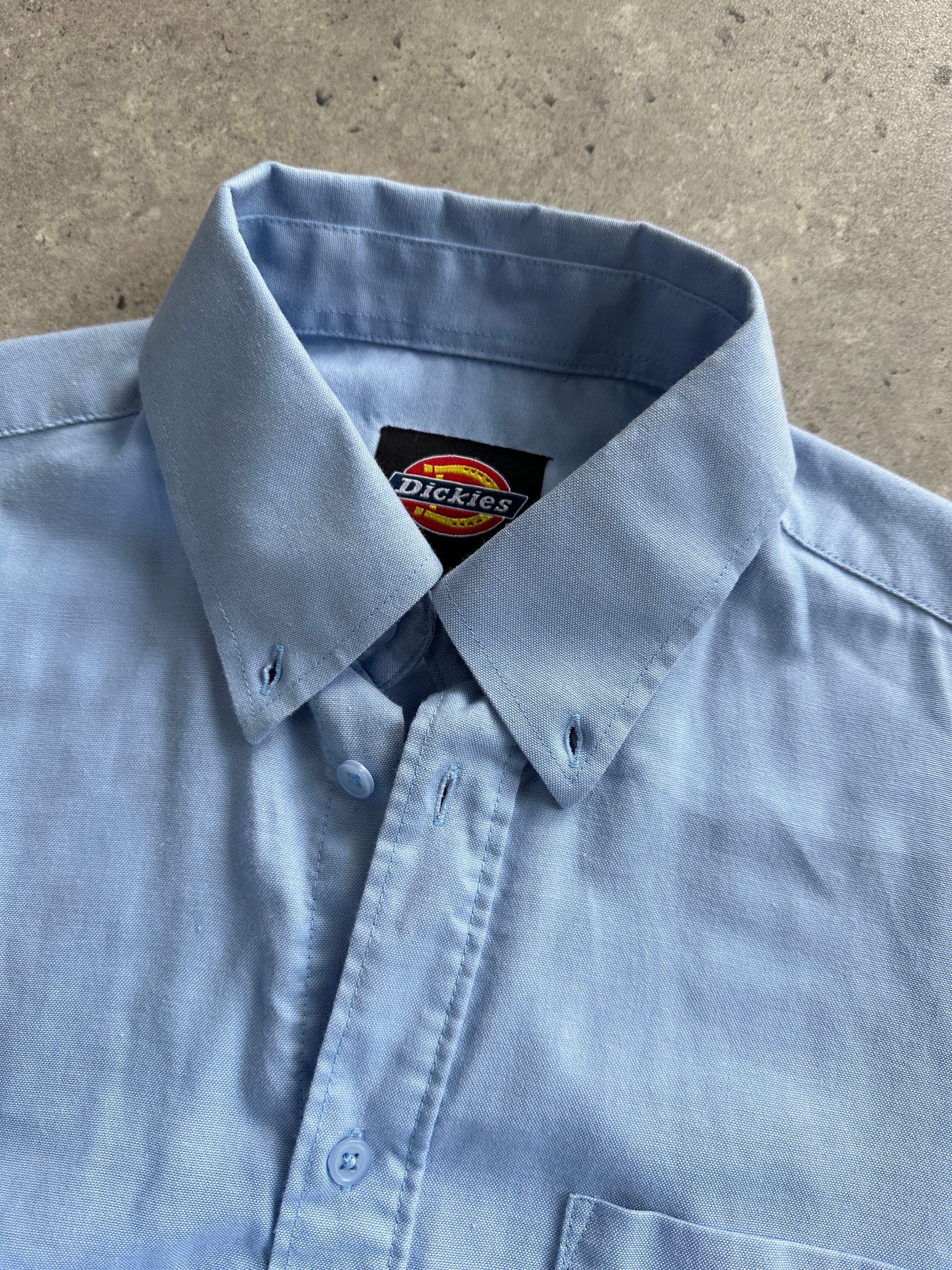 Dickies cotton shirt in size large/extra large, casual button-up with a classic collar and long sleeves, in a neutral color.