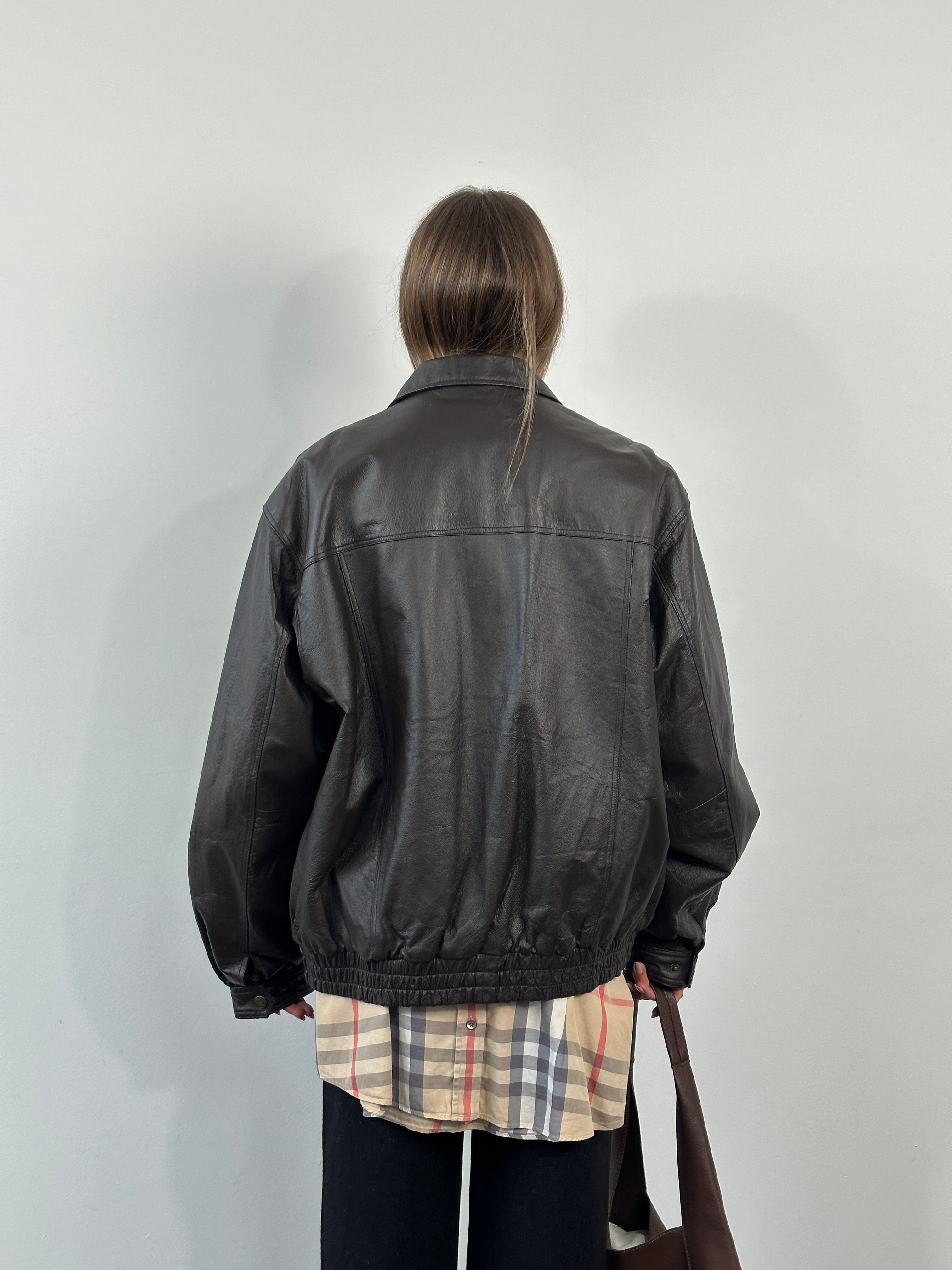 Vintage 1990s leather bomber jacket with concealed placket in XL/XXL size, featuring classic design and durable leather construction.