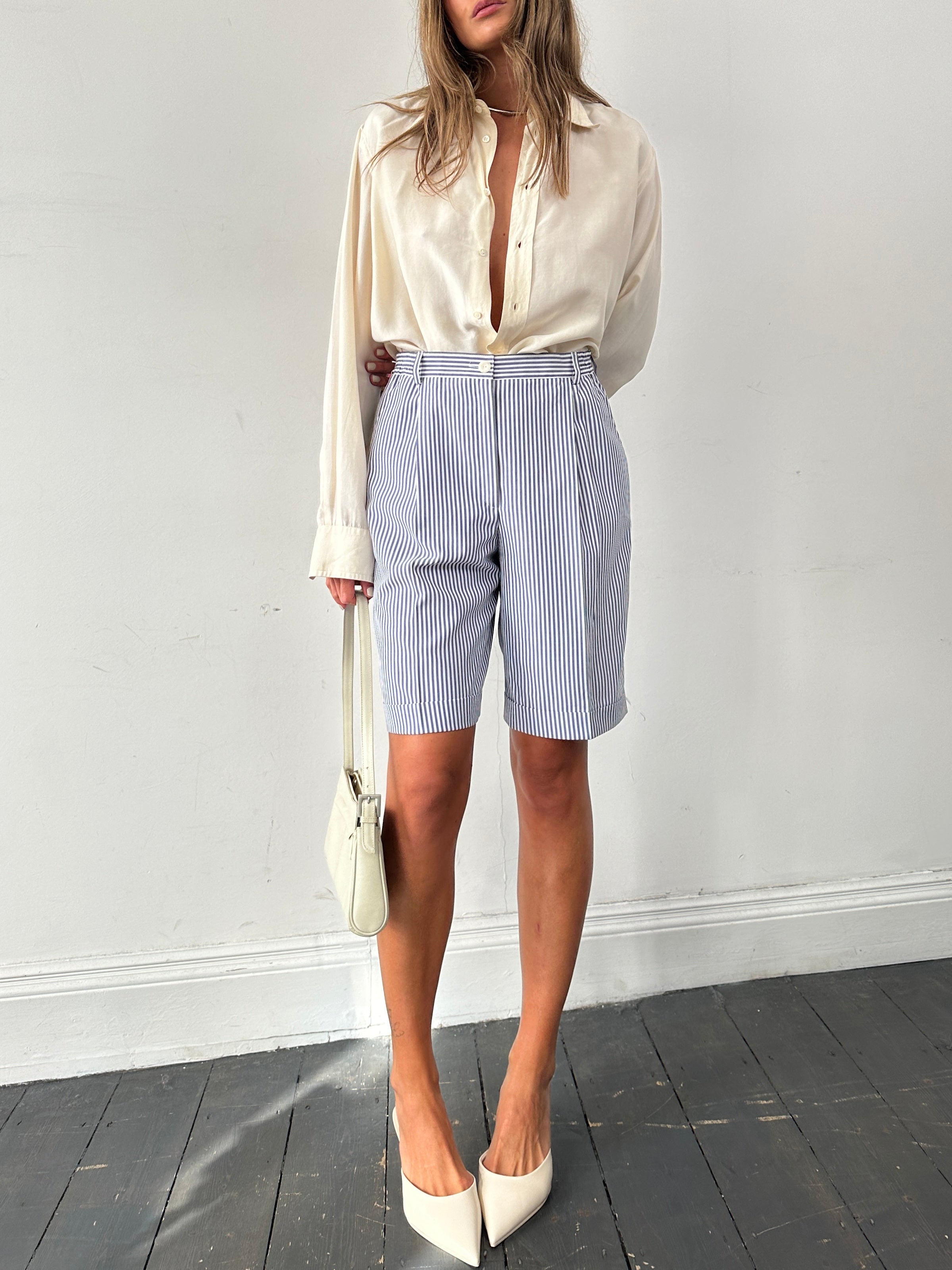 Vintage brand vintage stripe pleated shorts in W28 with a high waist, showcasing their colorful, retro-inspired design.