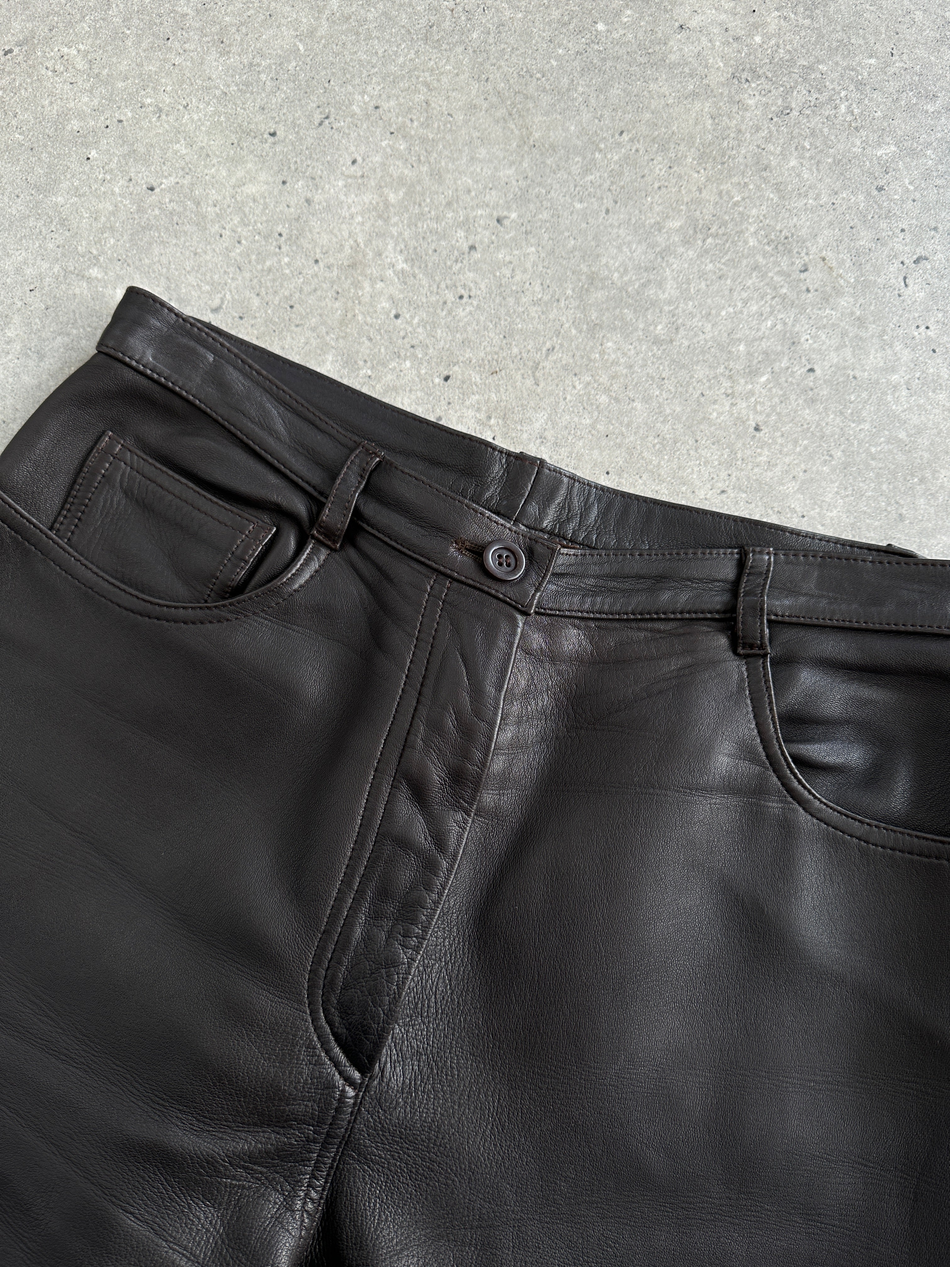 Black leather Jaeger 90s straight leg trousers with W30 waist, displayed flat on a neutral background.