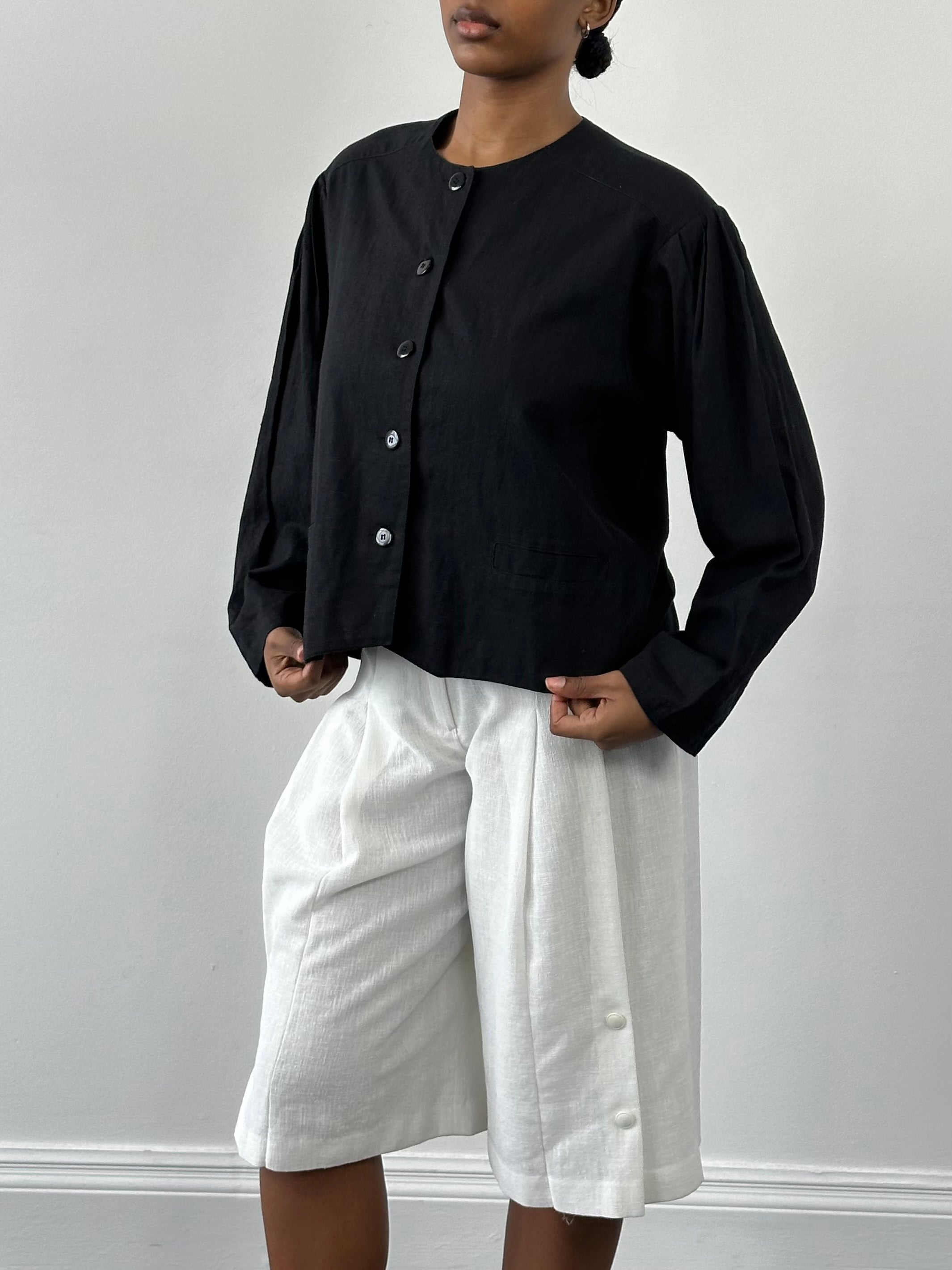 Vintage 1990s linen cotton boxy crop jacket in beige, featuring a classic collar and button front, displayed on a hanger.