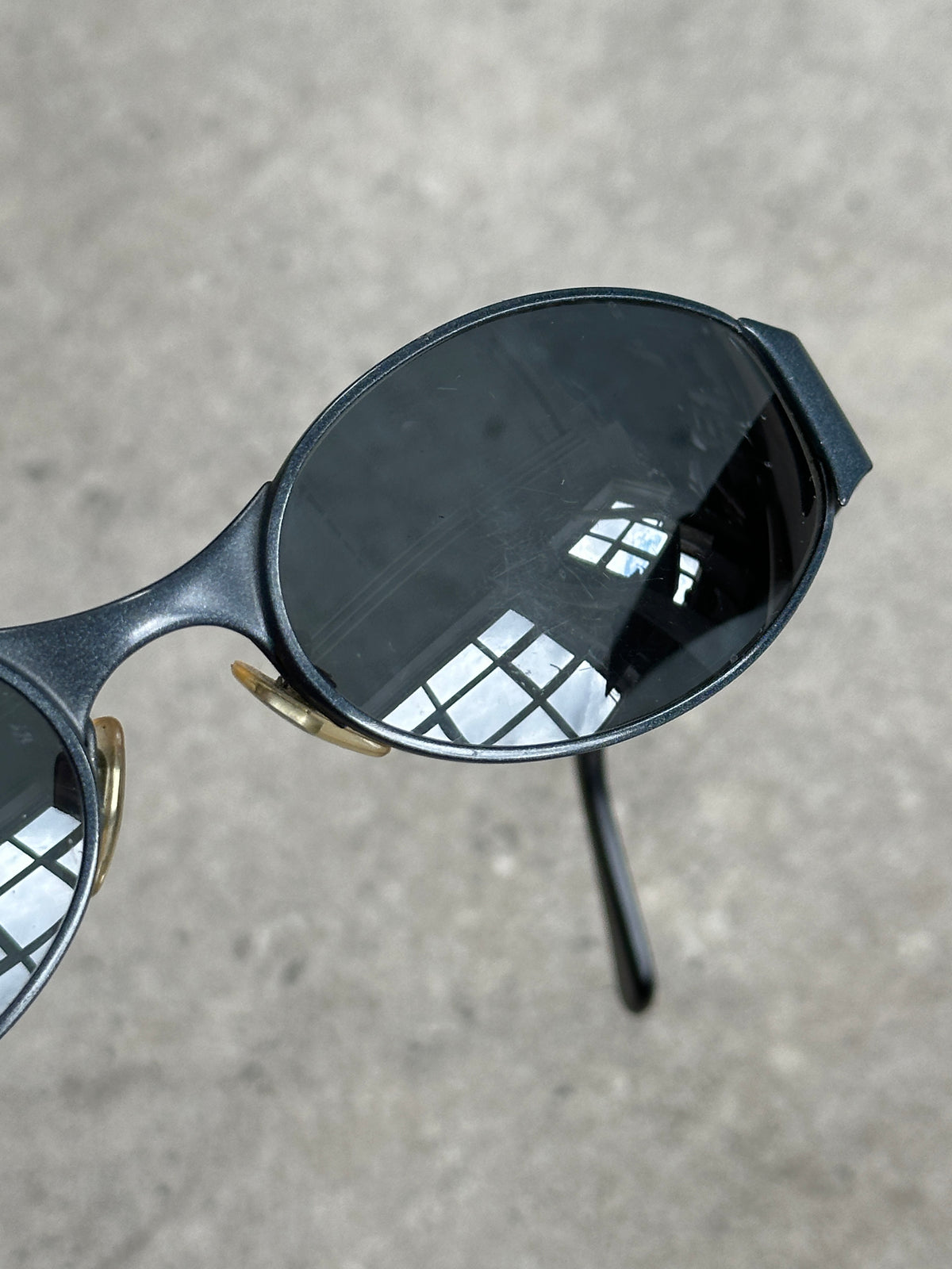 Emporio Armani 1990s oval logo sunglasses with black frames and dark lenses, stylish eyewear featuring the Armani brand logo.