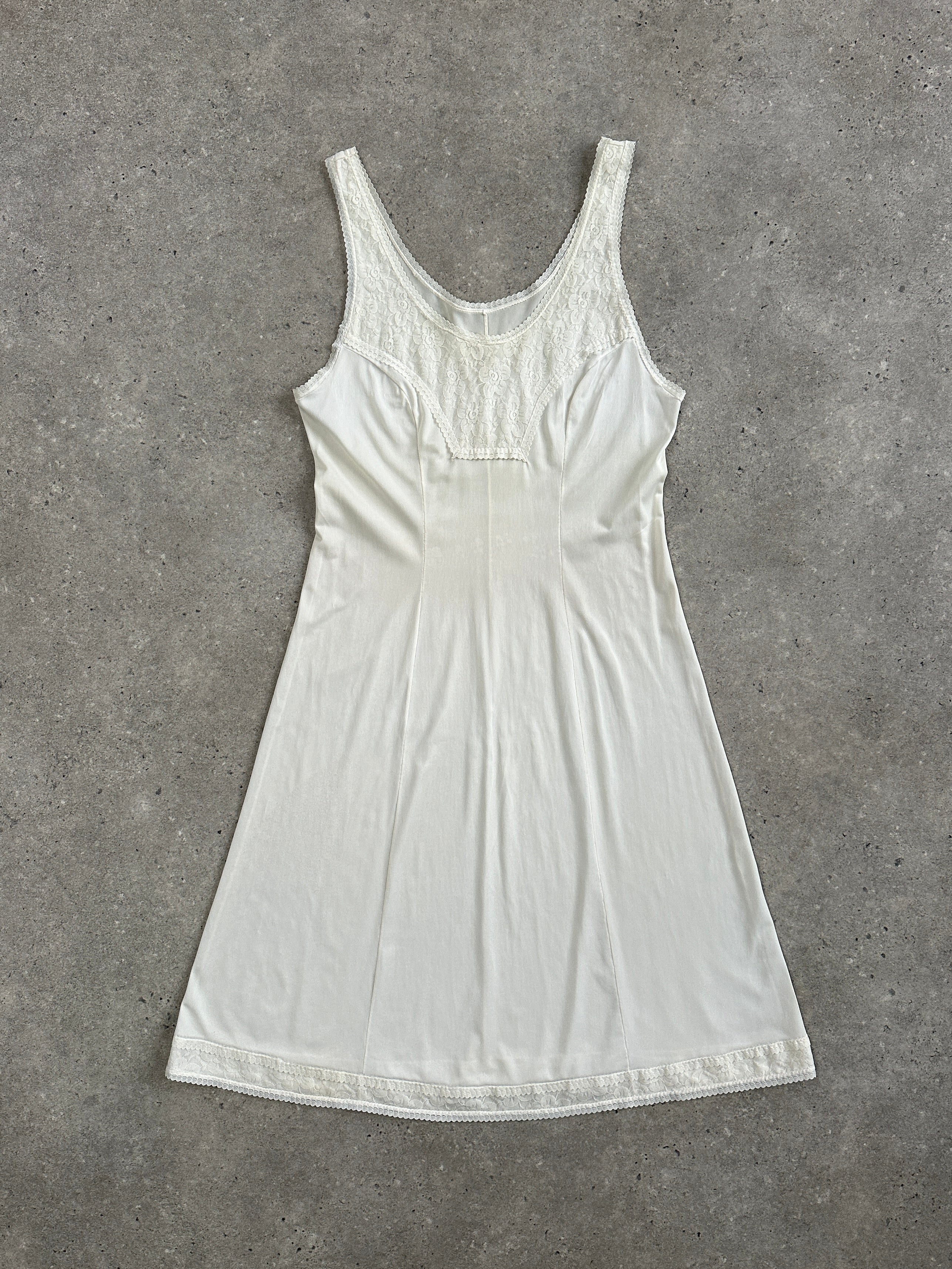 Vintage 1990s lace mini slip dress in size S, featuring delicate lace fabric and a classic vintage style.