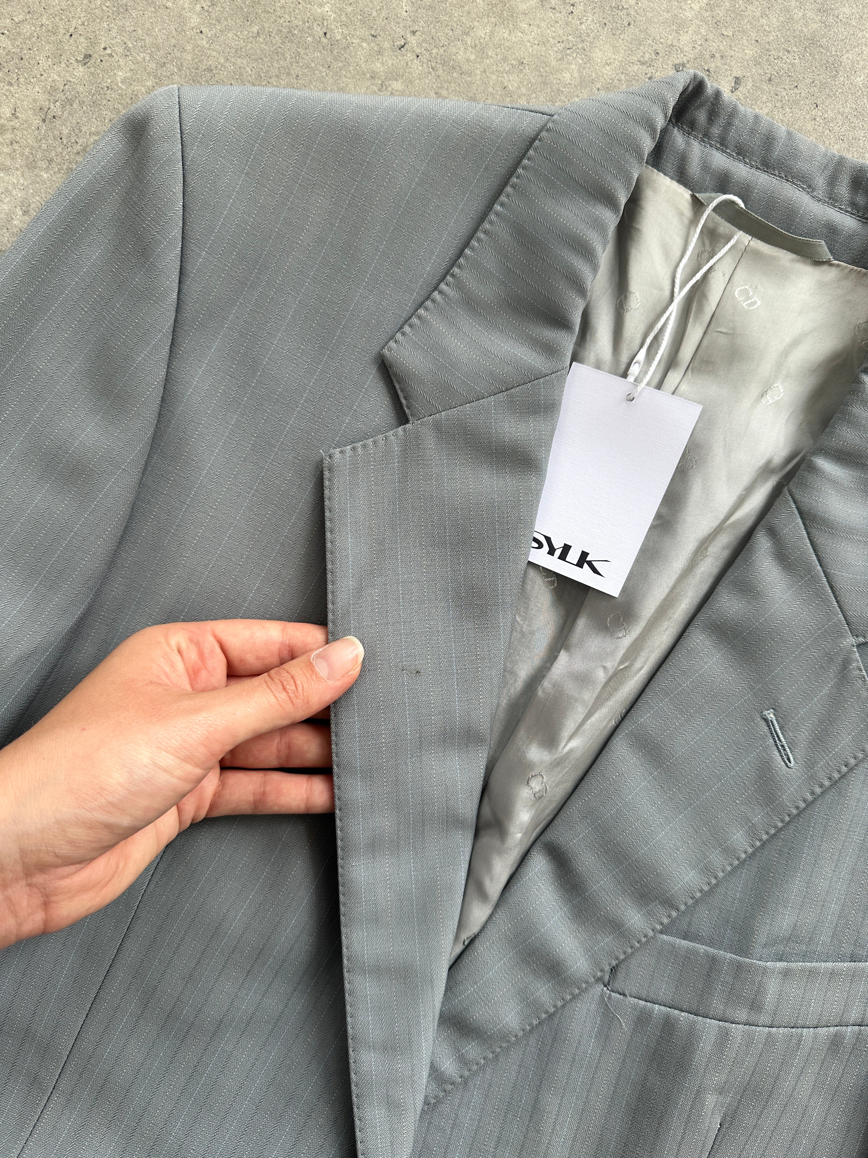 Christian Dior wool single-breasted suit jumpsuit in size 44R/W32, tailored fit with lapel collar and front buttons.